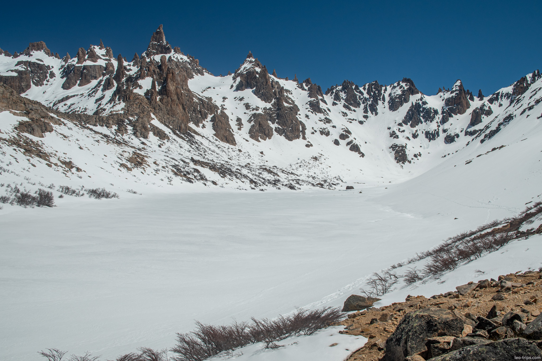frozen lake beneath jagged spires frey refuge trail