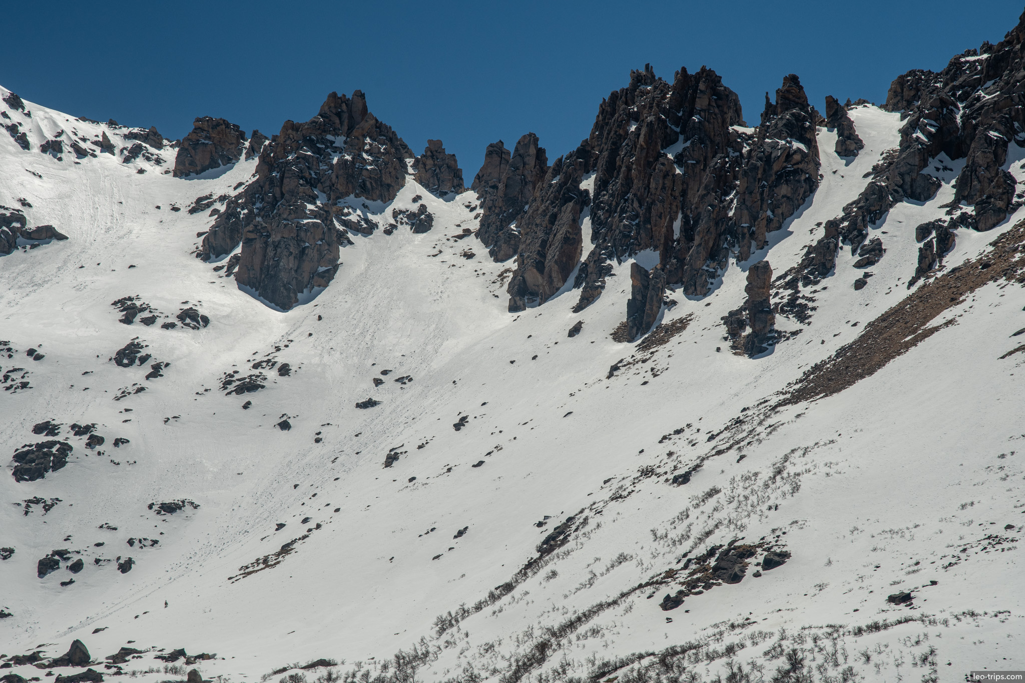jagged rock spires above snowfield frey refuge trail