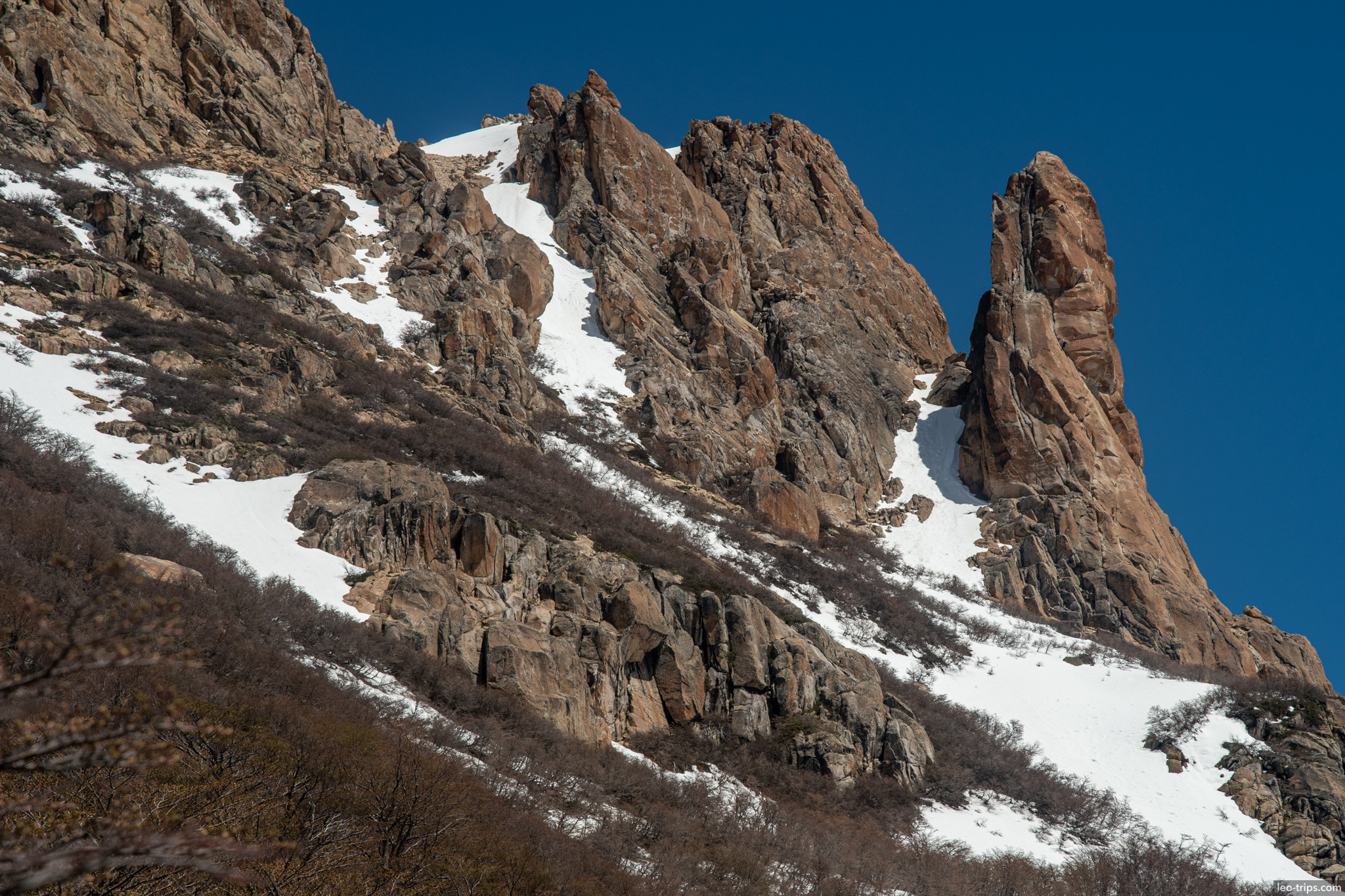 reddish rock spire on slope frey refuge trail