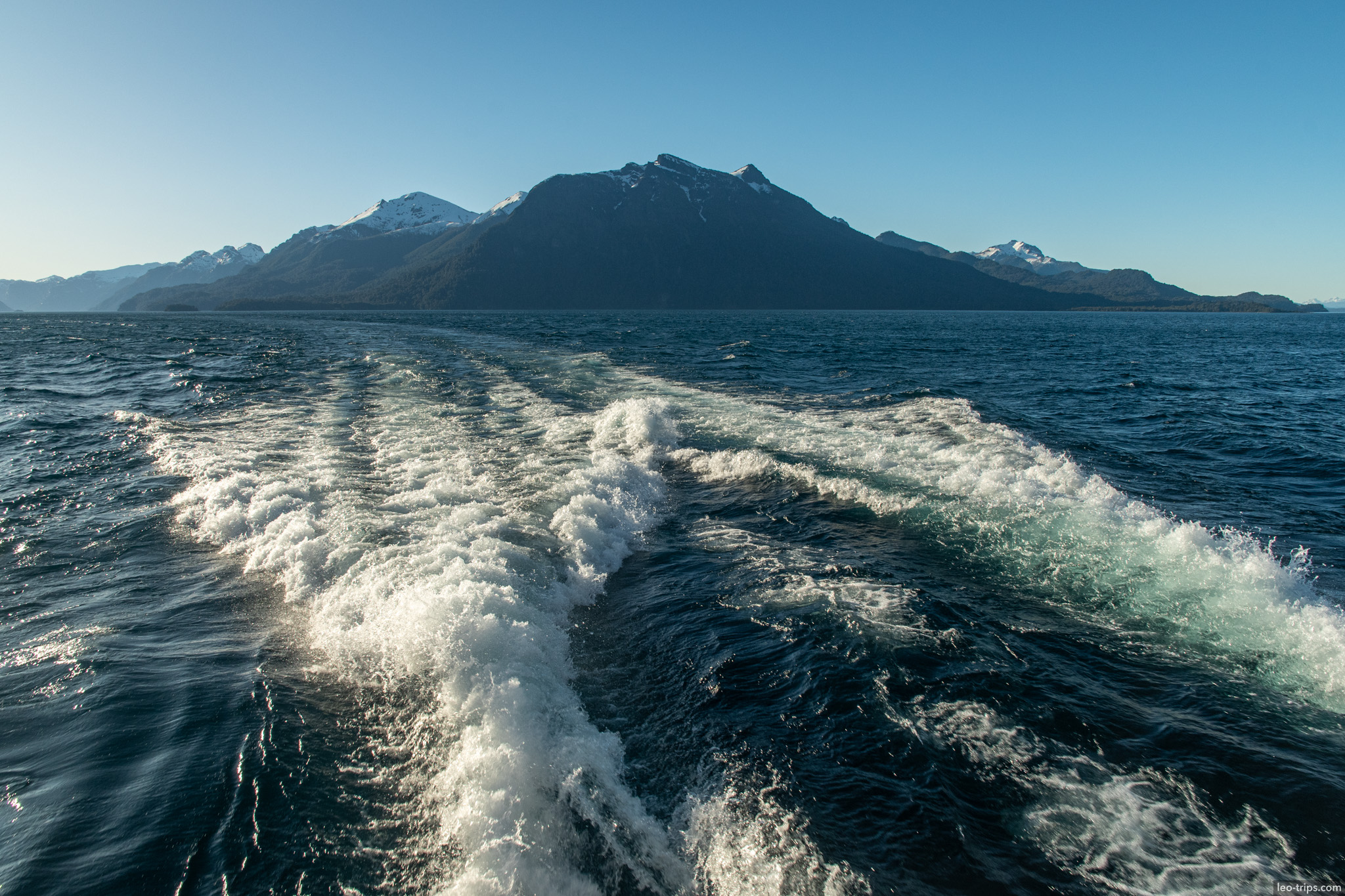 boat wake toward dark mountain puerto blest