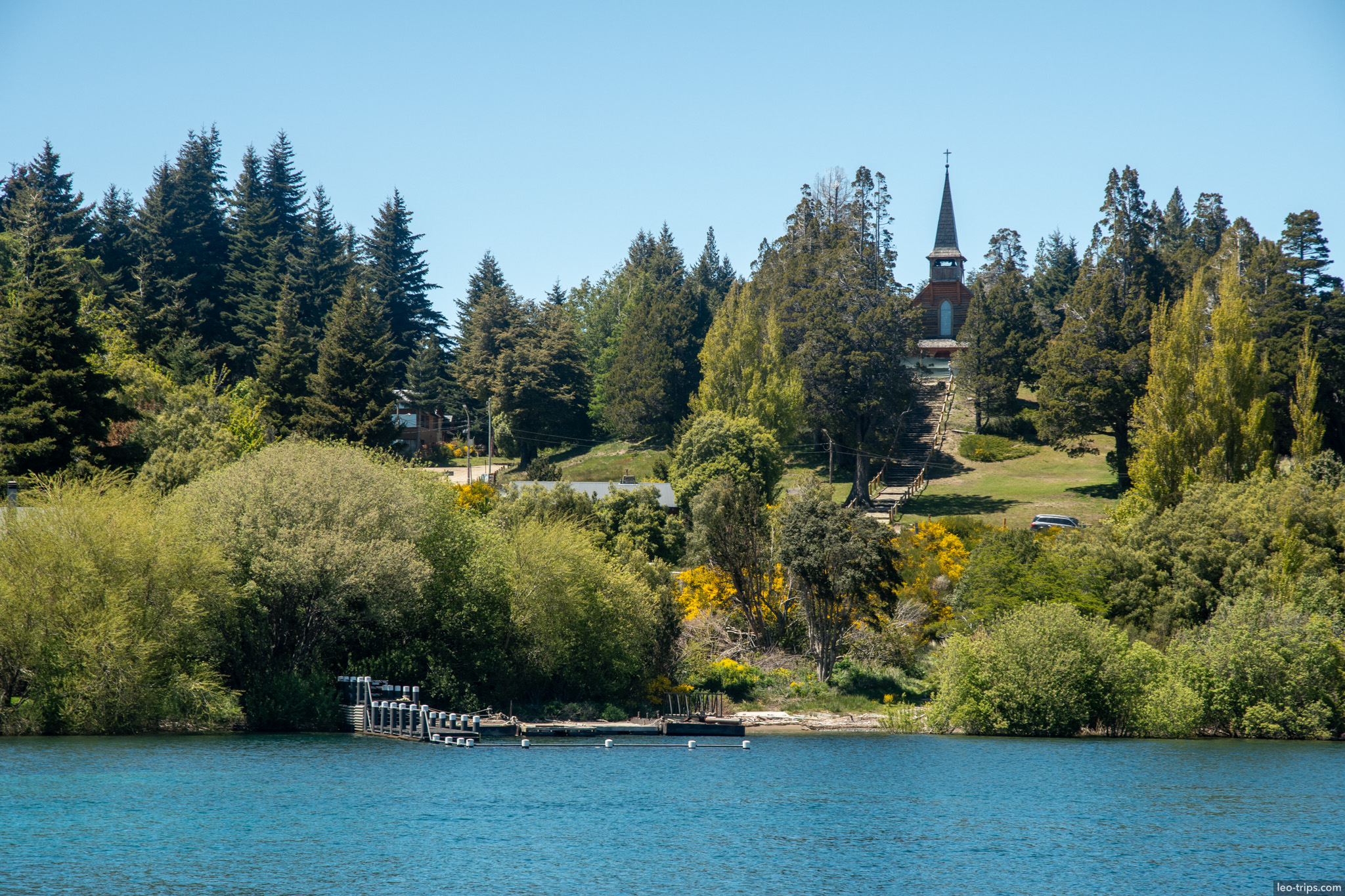 lakeside chapel steeple through trees puerto blest