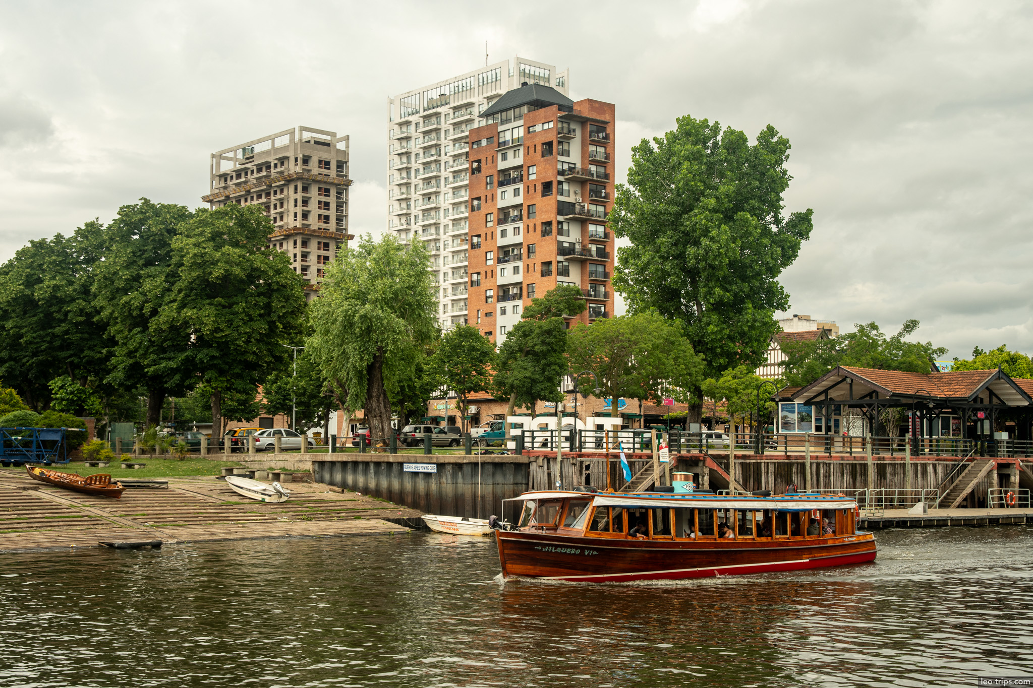 river view apartment towers wooden boat tigre