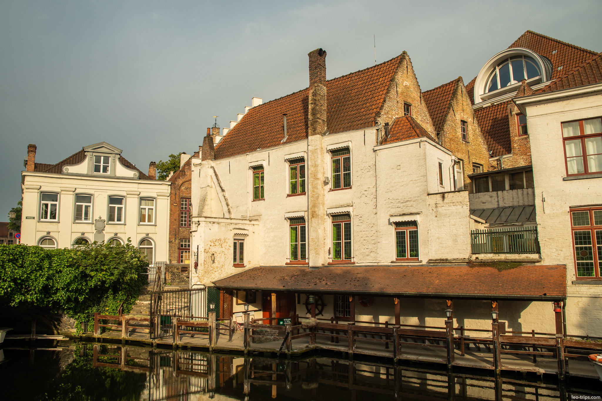 bruges canal waterfront houses wooden dock morning bruges