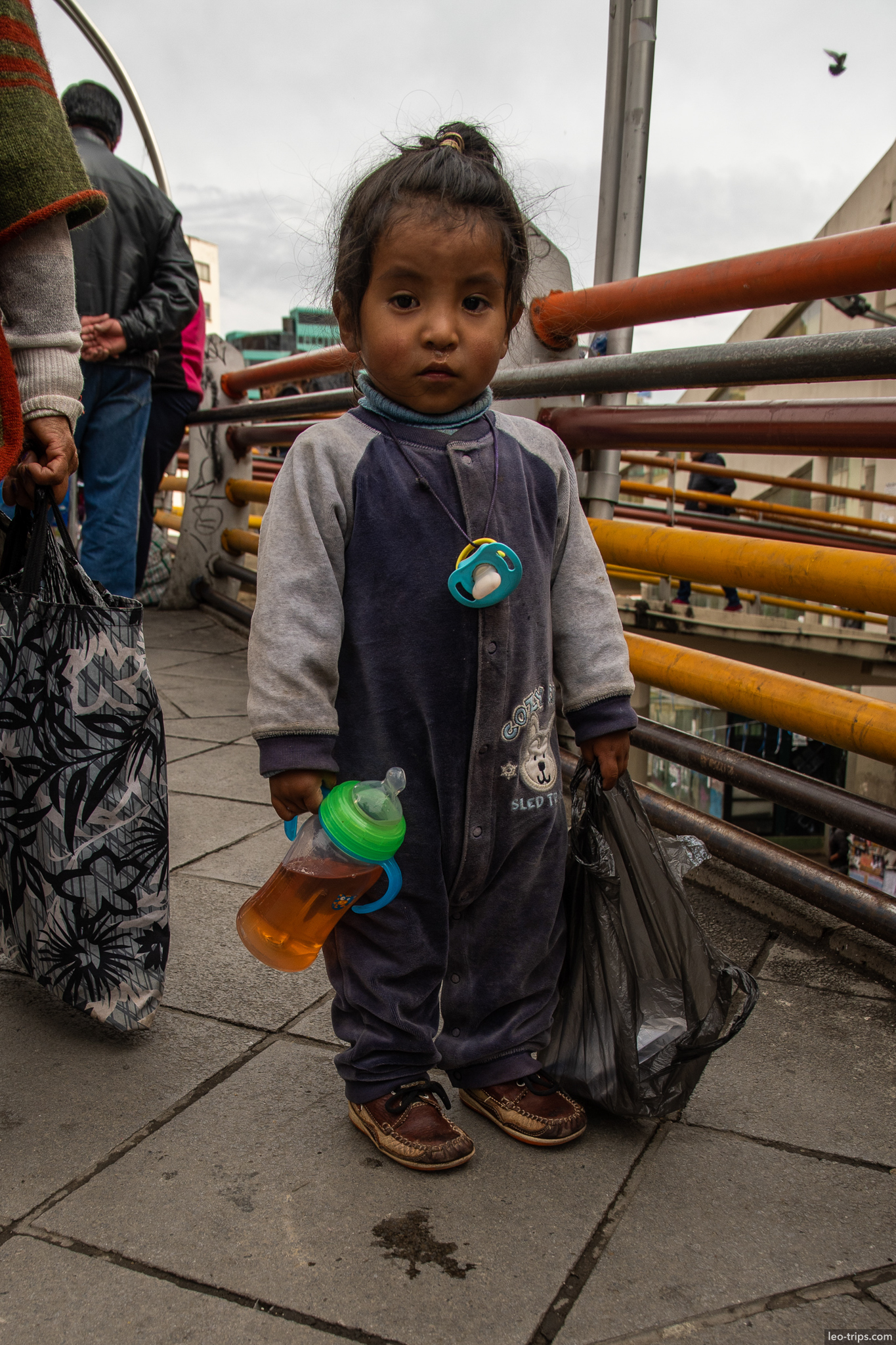 la paz toddler with bottle bridge railing la paz