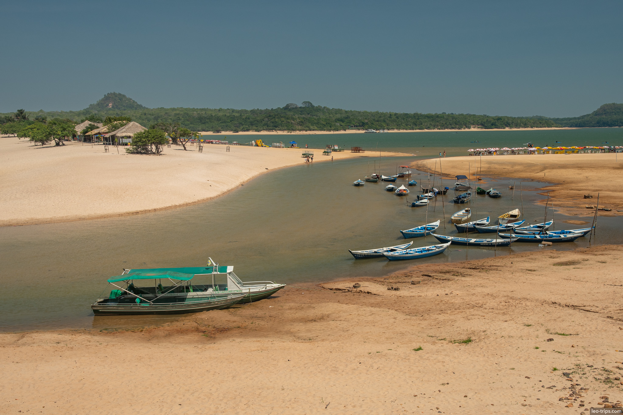 wide beach view with boats and hills alter do chao