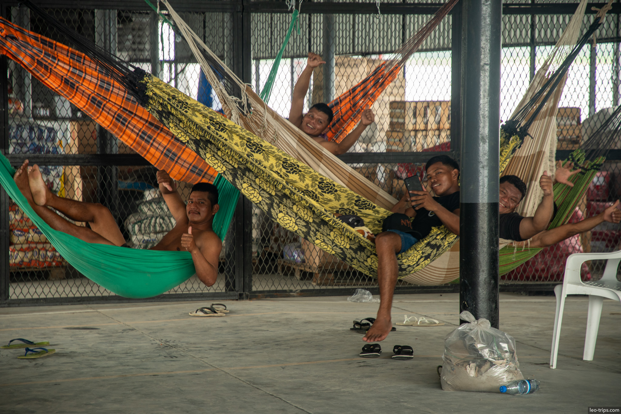 crew of a boat in hammocks amazon river