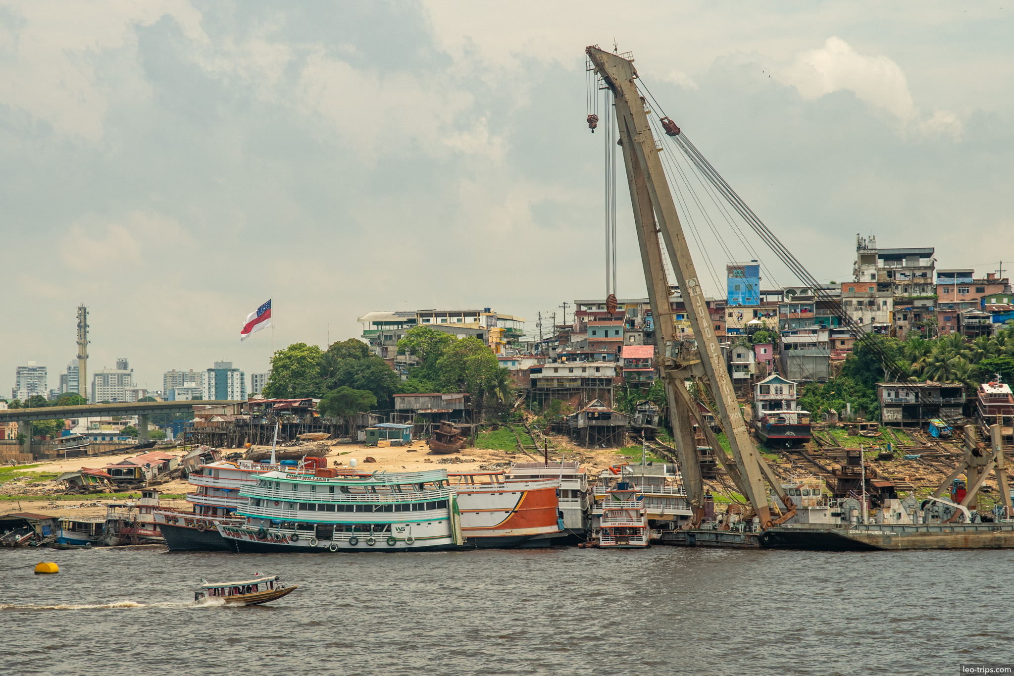 wrecked boats and crane on amazon amazon river