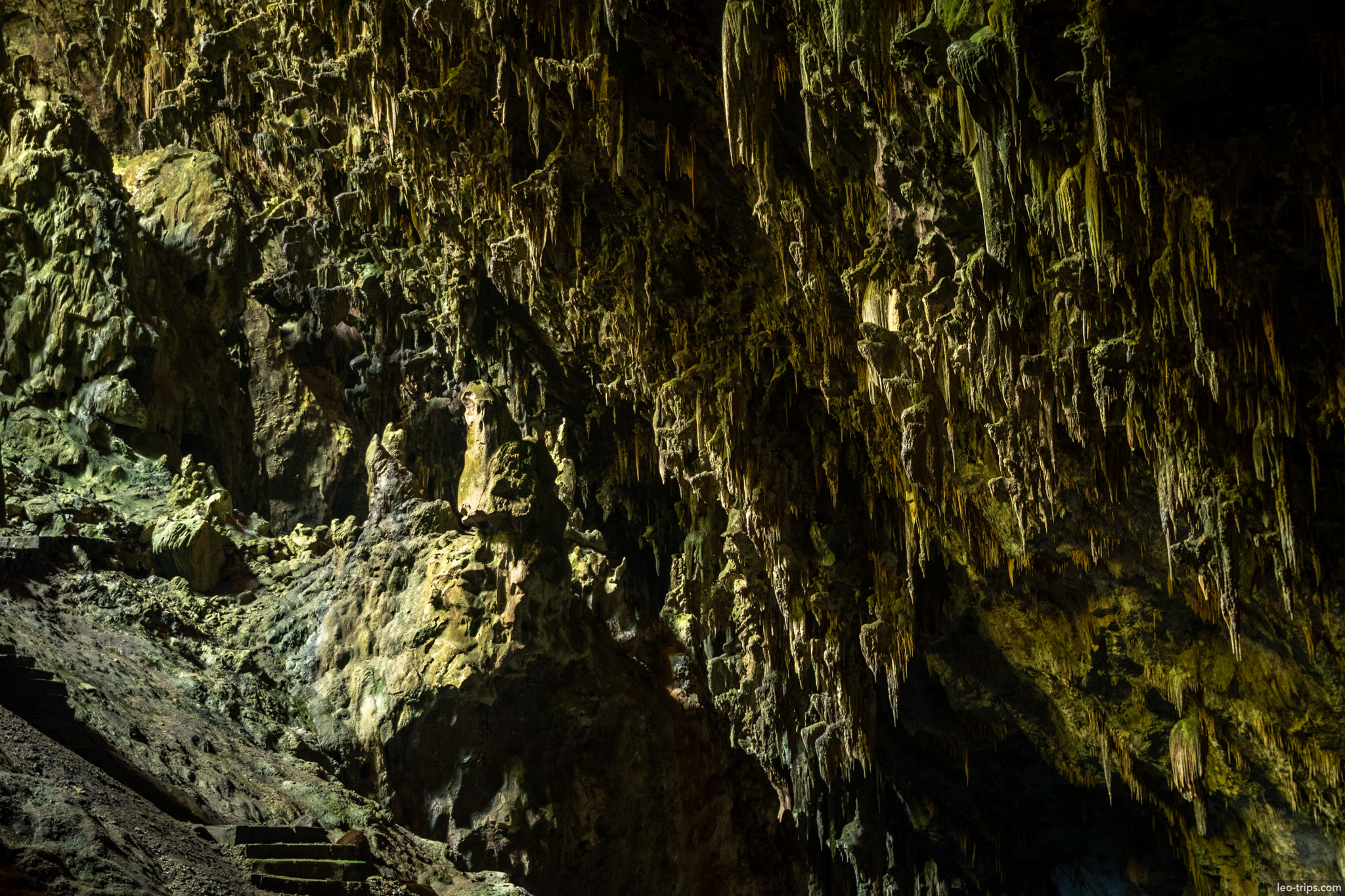 stalactite covered cave wall and stone steps gruta do lago azul gruta do lago azul