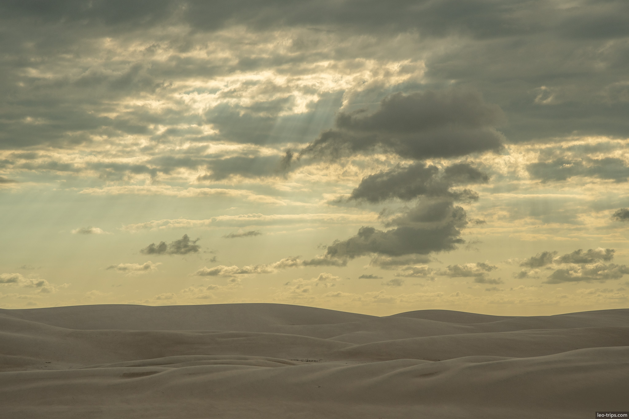 white sand dunes dramatic cloudy sky lencois lencois maranhenses