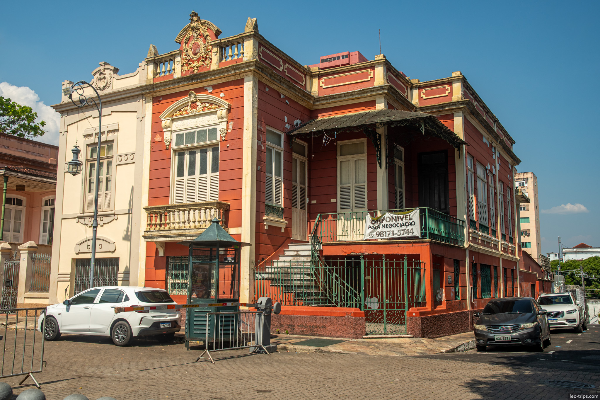 A beautifully restored colonial mansion with a vibrant orange and cream facade in the historic center of Manaus