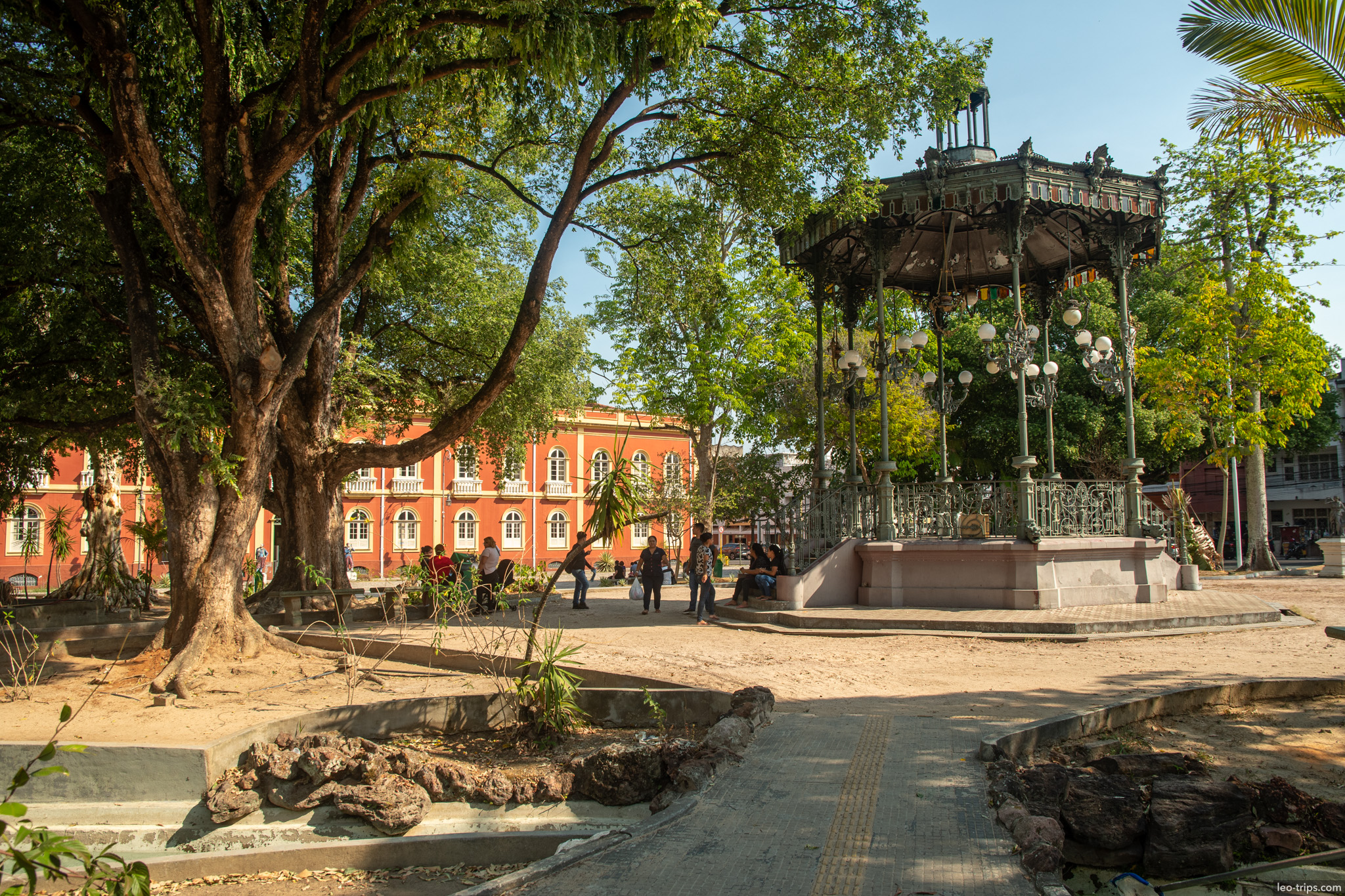 A tranquil view of the iron bandstand (gazebo) nestled among the trees in the historic Praça Heliodoro Balbi