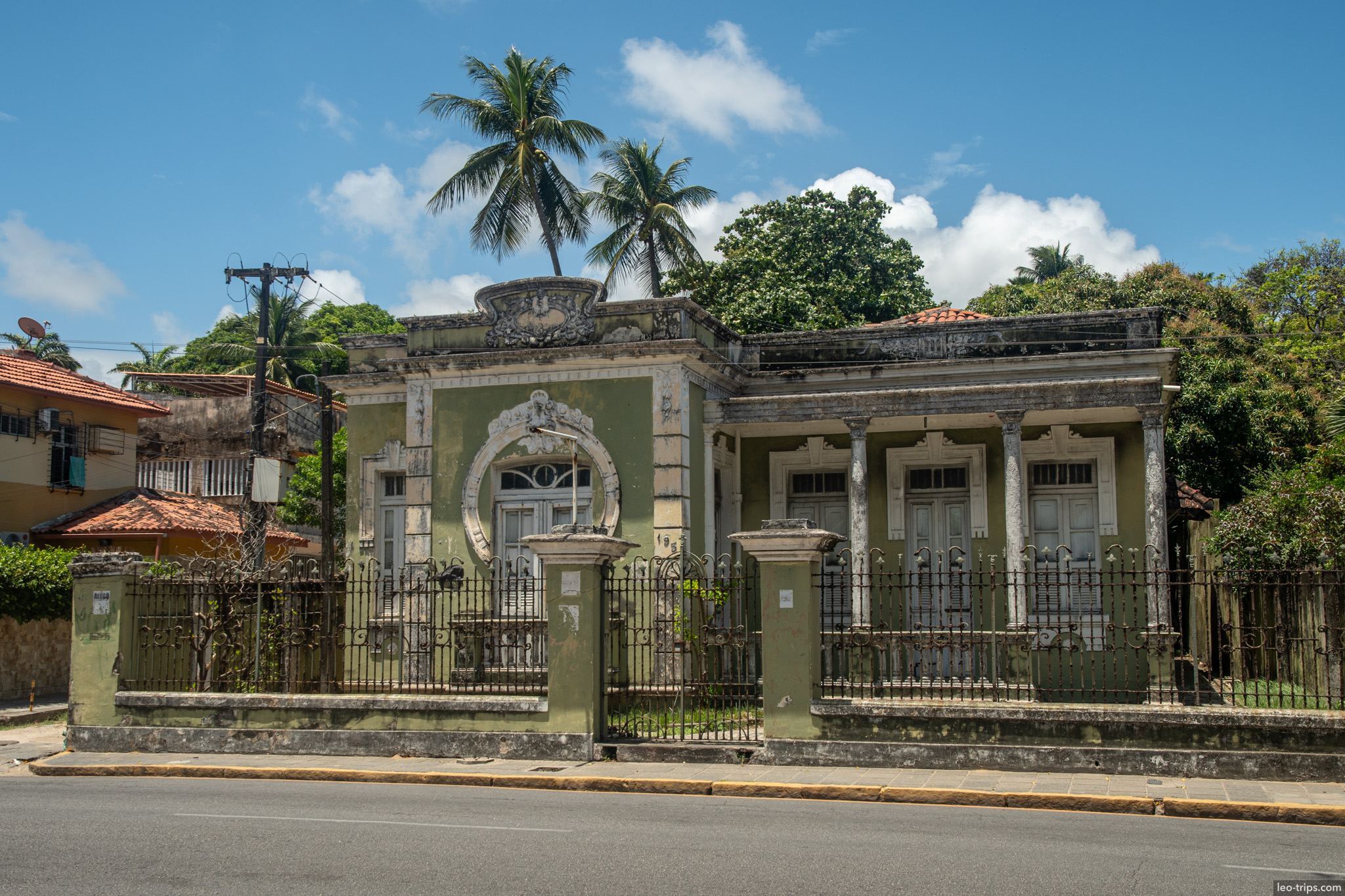 abandoned neoclassical green mansion with iron fence olinda olinda