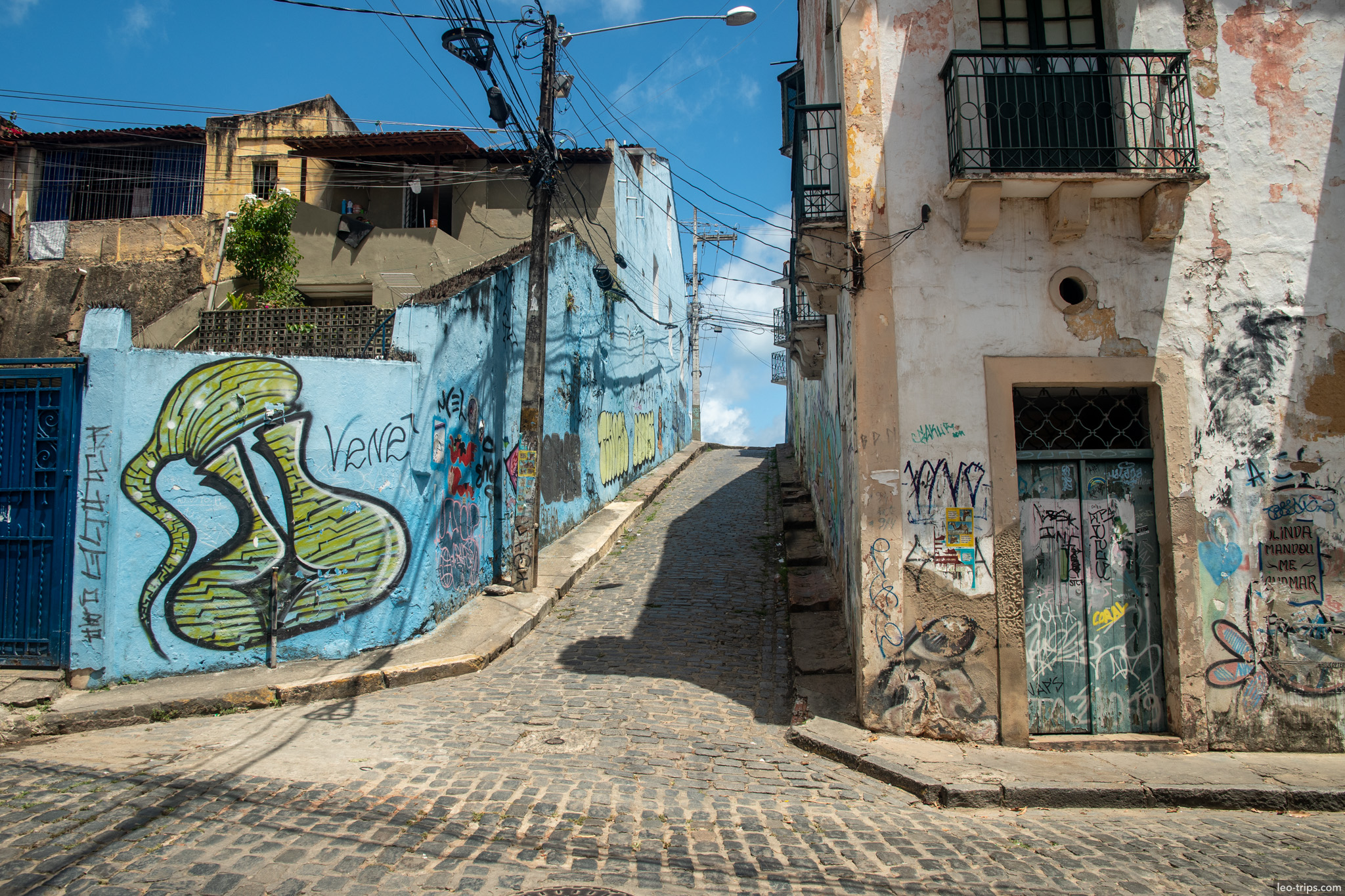 narrow cobblestone alley graffiti walls olinda olinda