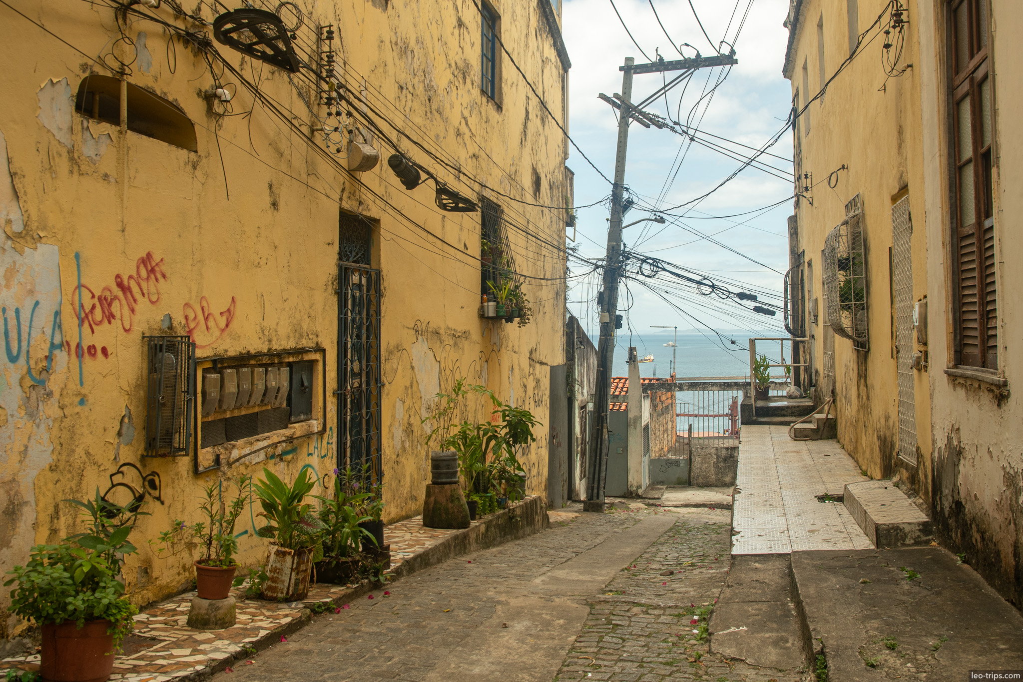 narrow yellow alley power lines sea view salvador salvador
