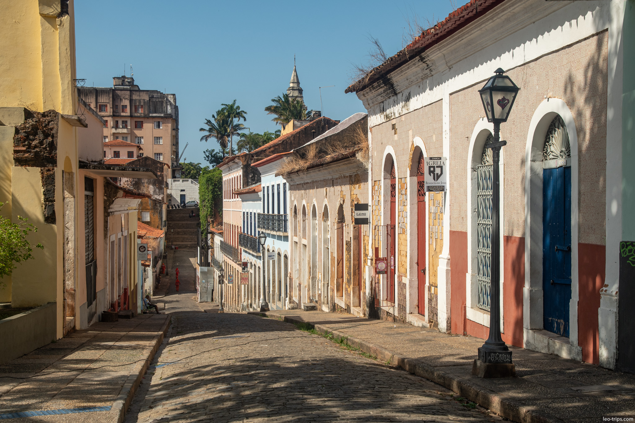 cobblestone hill street church spire sao luis
