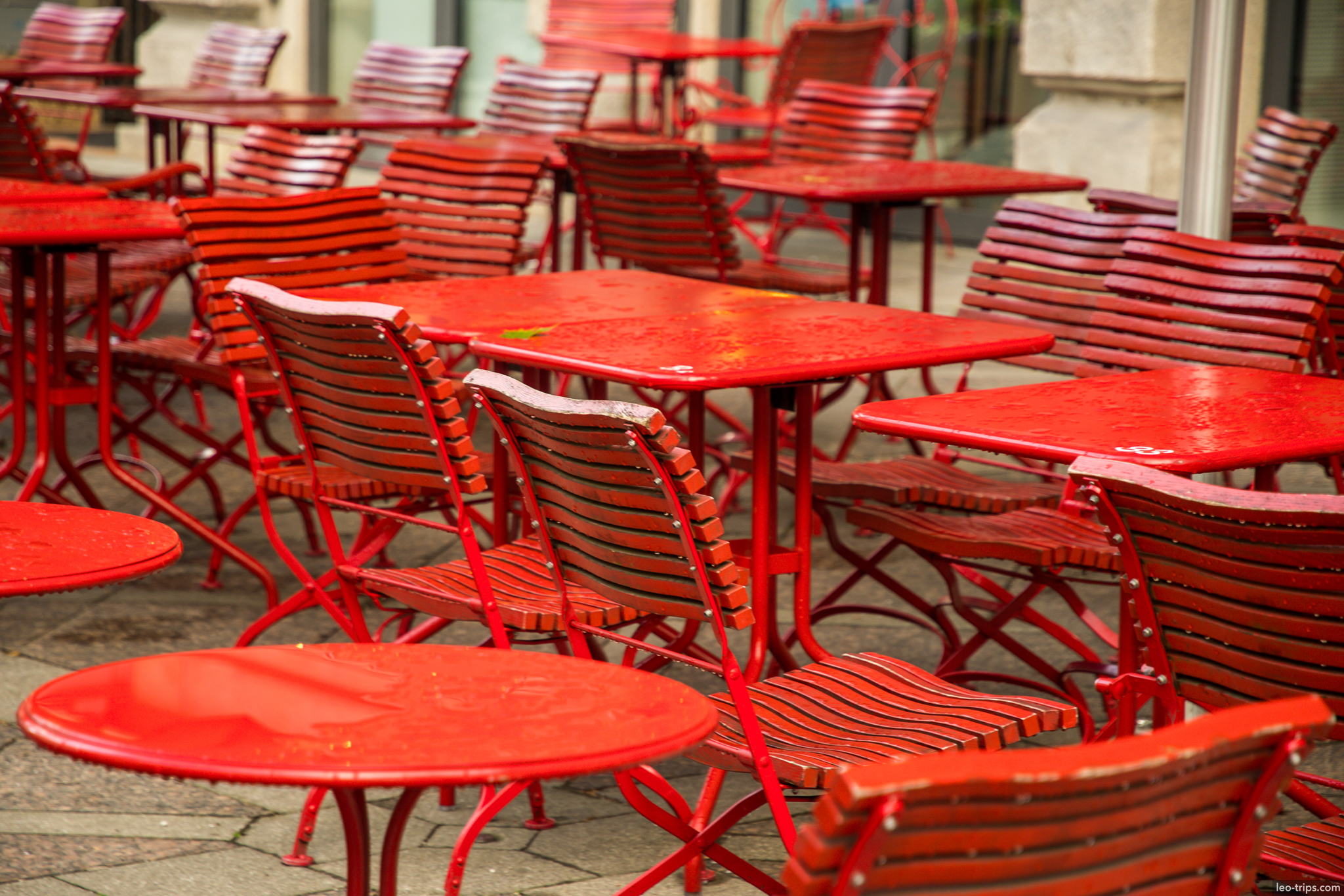 red cafe chairs tables wet outdoor munich