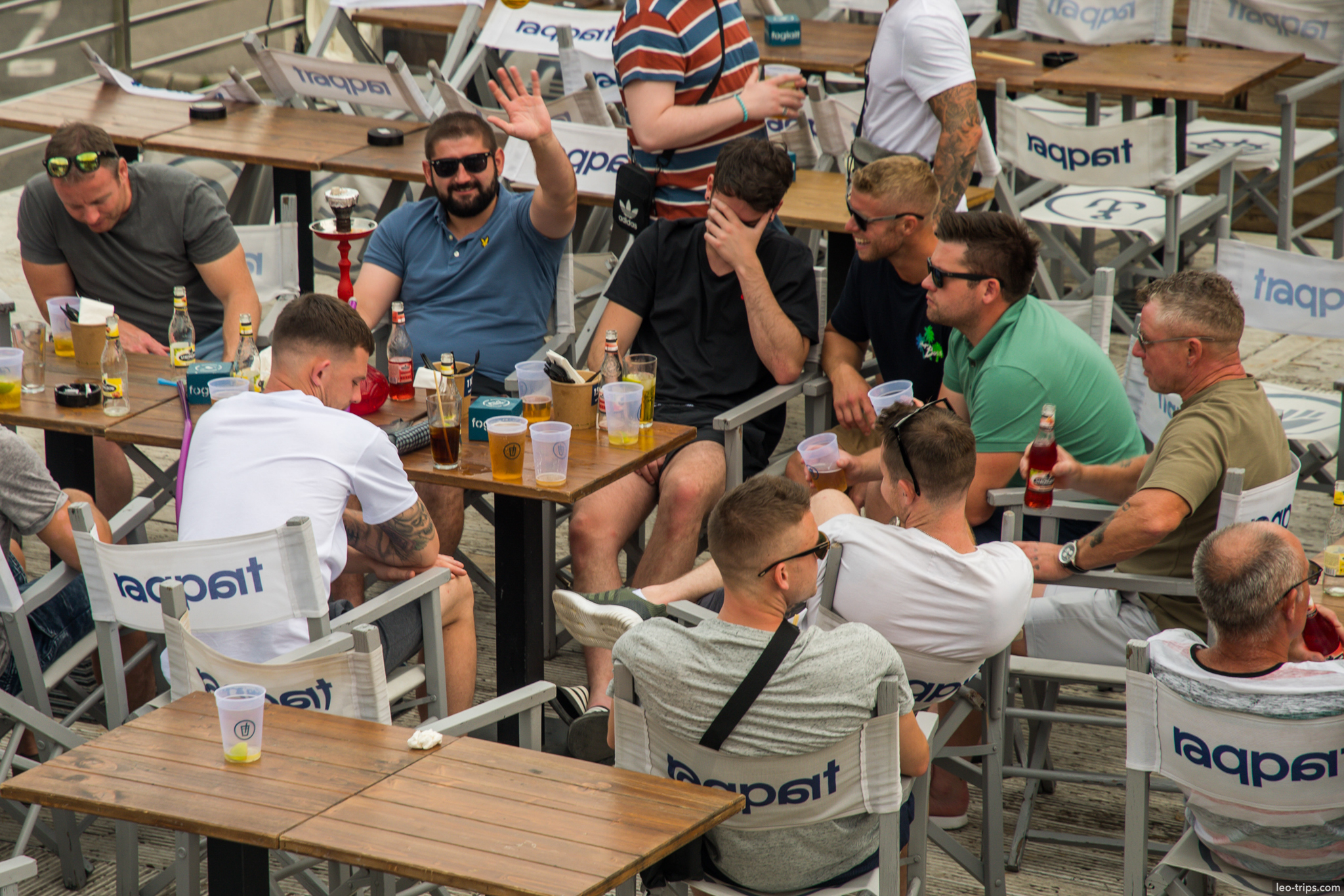 tourists drinking beer outdoor cafe budapest
