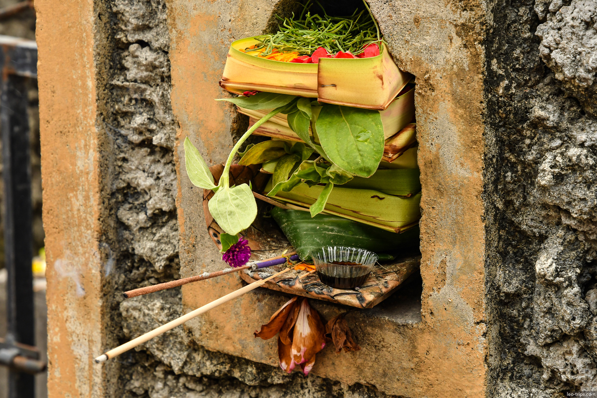 balinese canang sari offering in stone niche bali