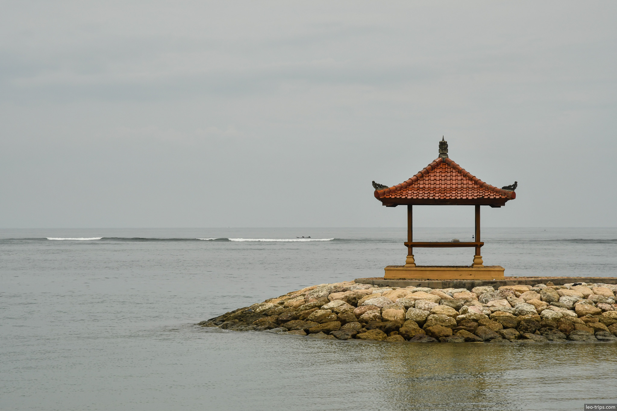 balinese gazebo on stone breakwater sanur bali