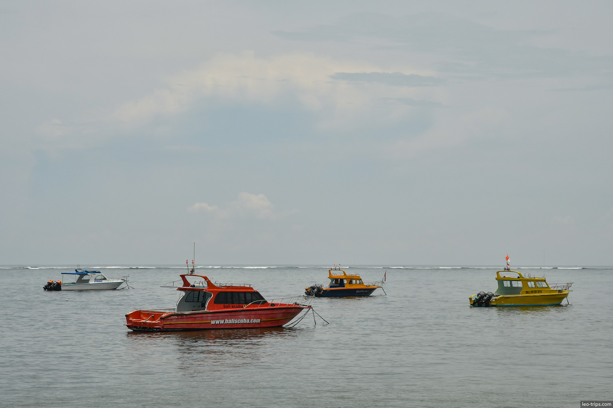 colorful dive and tour boats anchored offshore bali