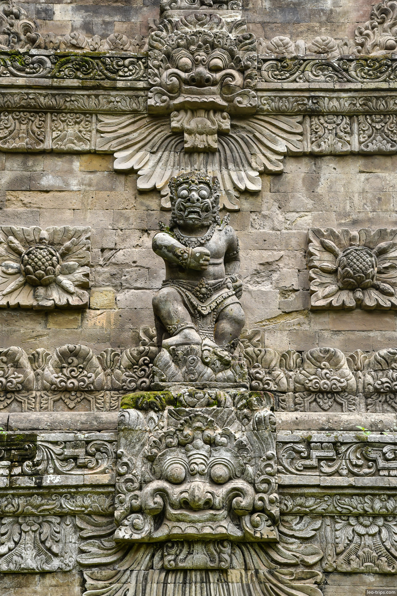 intricate bas relief demon figure temple wall bali
