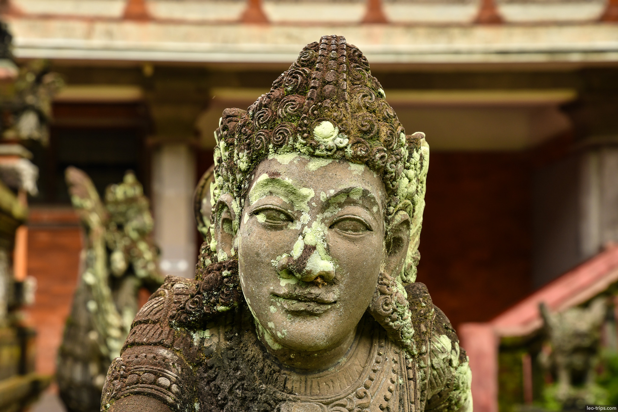 moss covered hindu deity statue closeup bali
