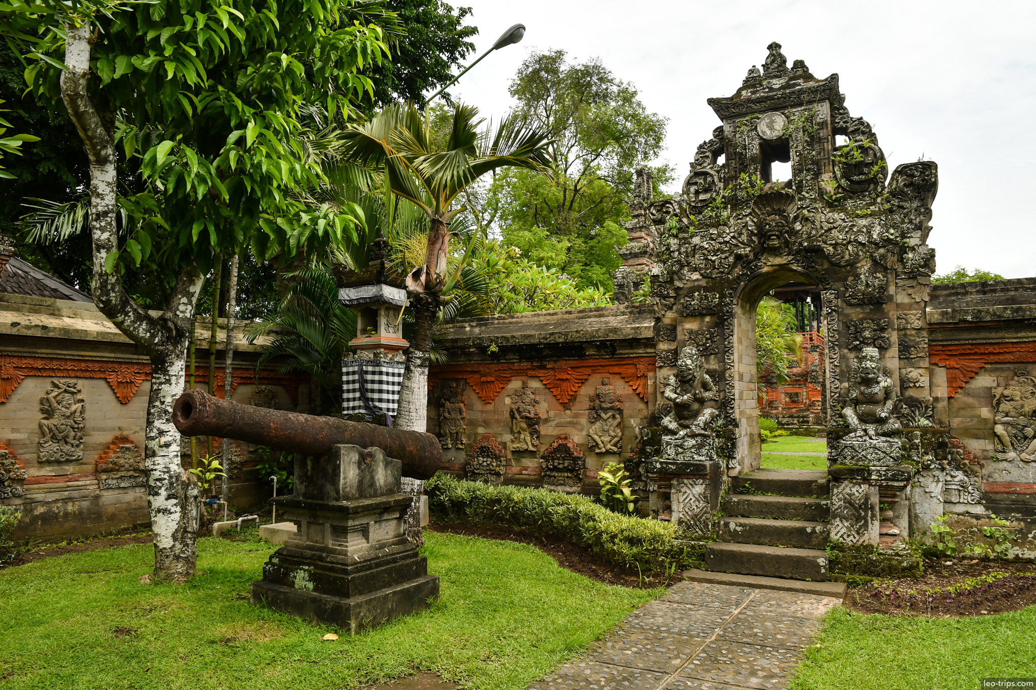 old cannon and carved stone gate bali museum bali
