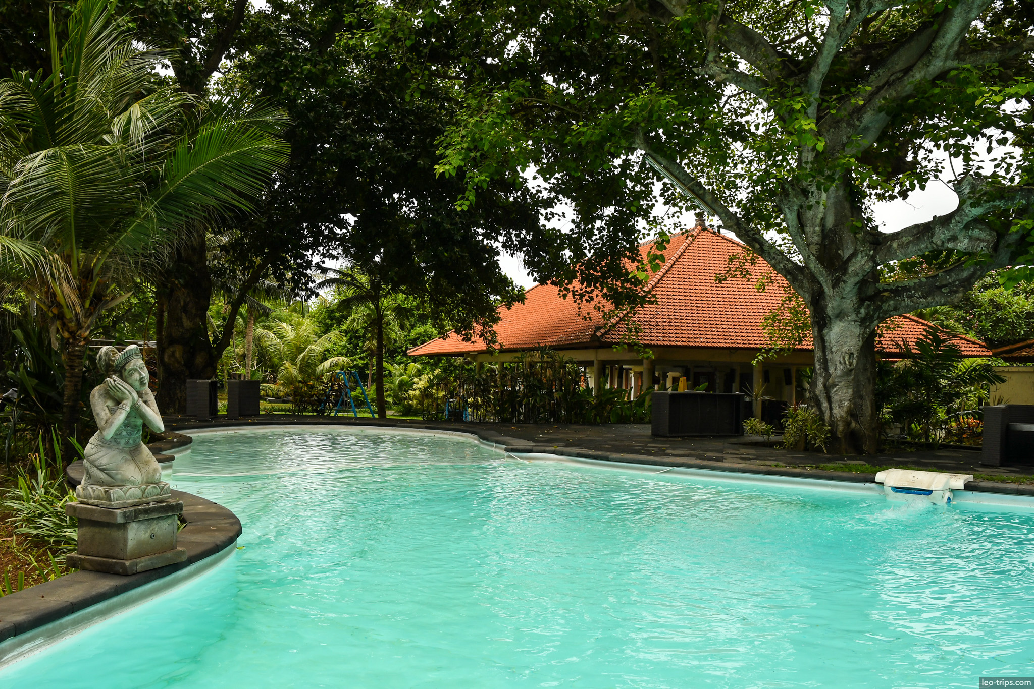 resort pool with stone statue sanur bali