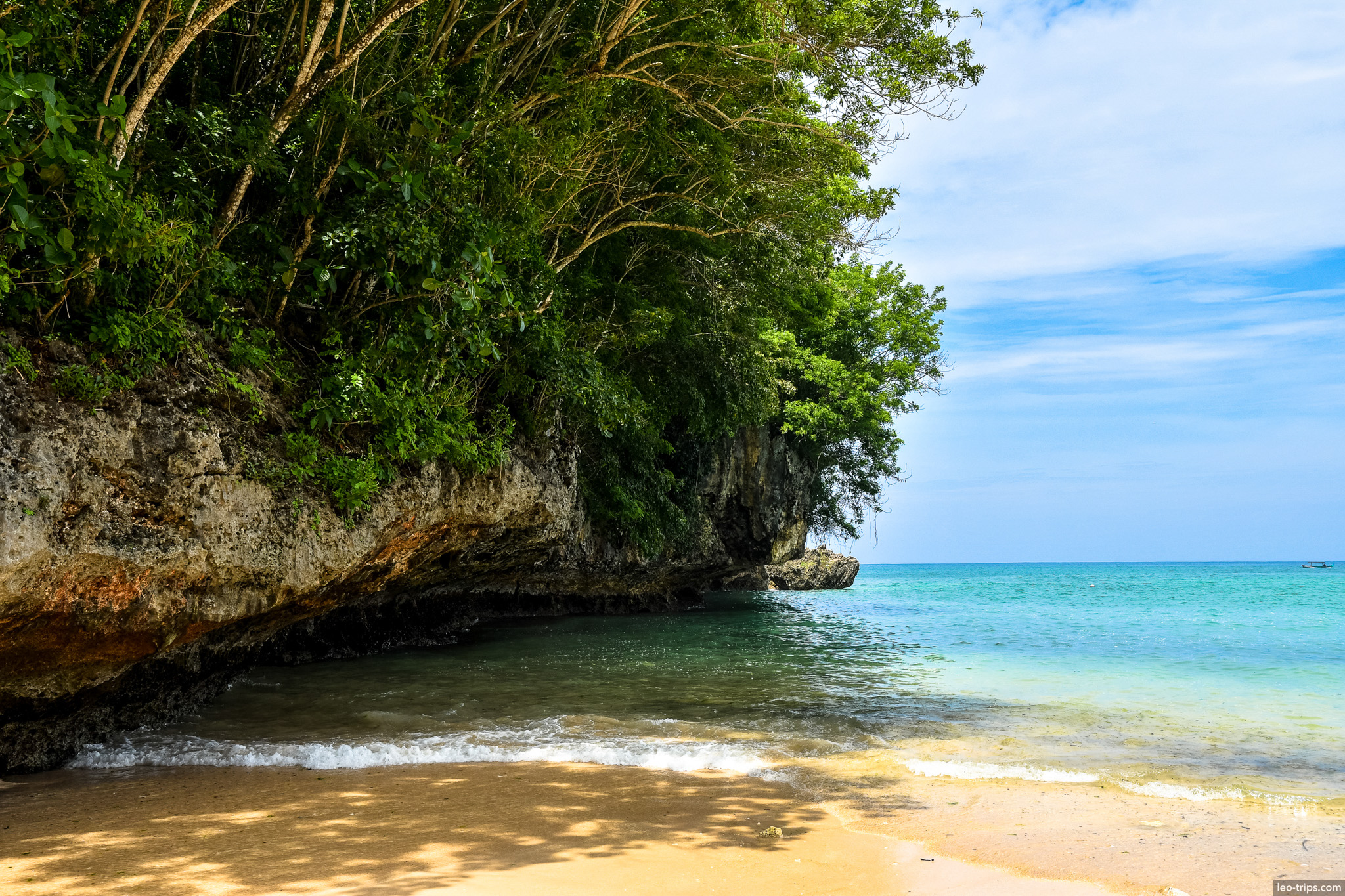 secluded beach cove with limestone cliff bali