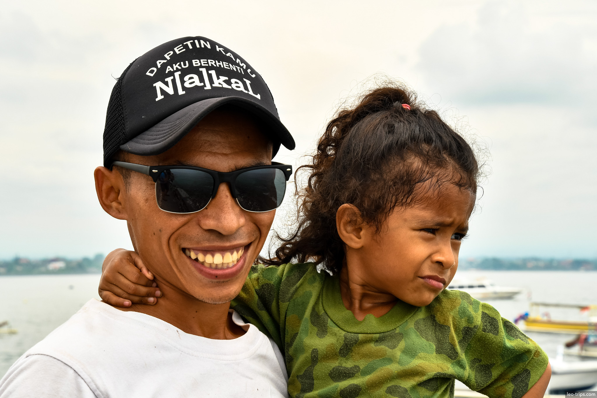 smiling father and daughter at harbor bali