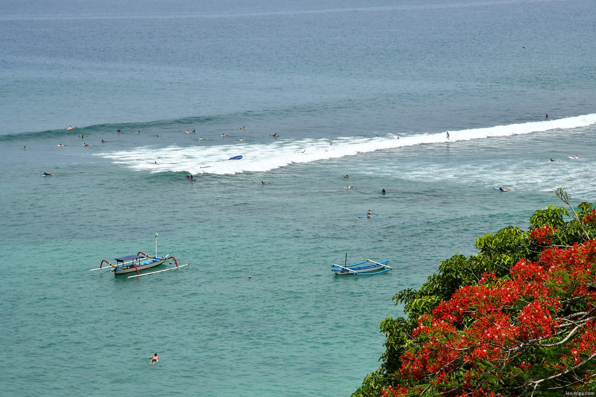 surfers waiting for waves jukung boats aerial bali
