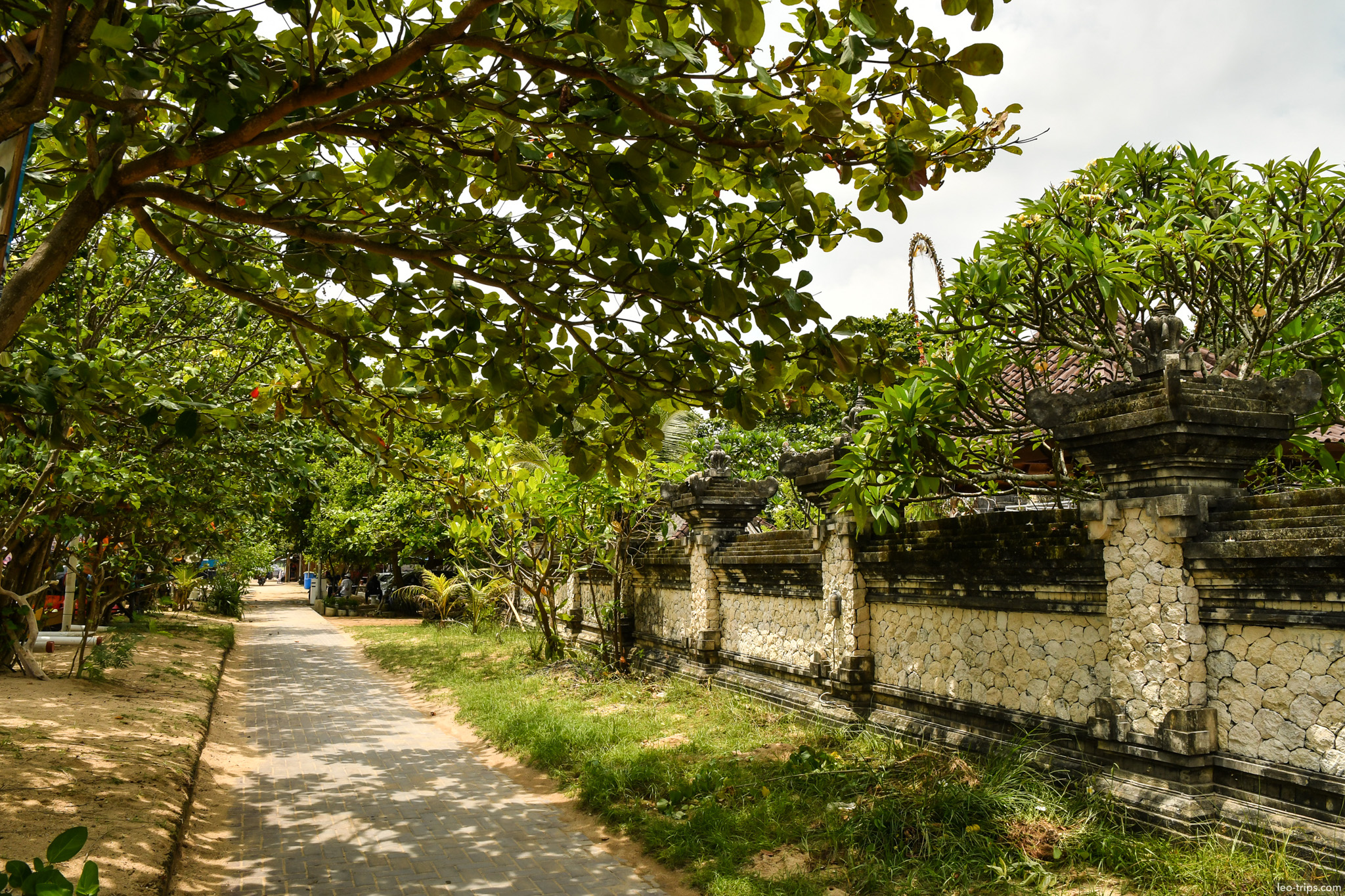 tree lined path along temple wall sanur bali