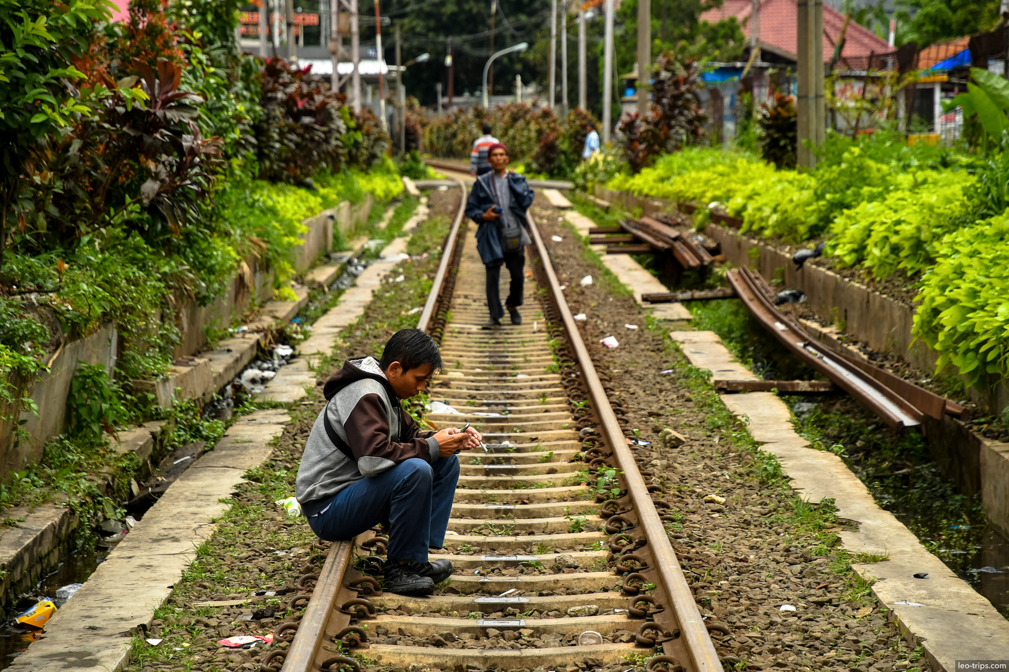 boy sitting on railway tracks bogor bogor