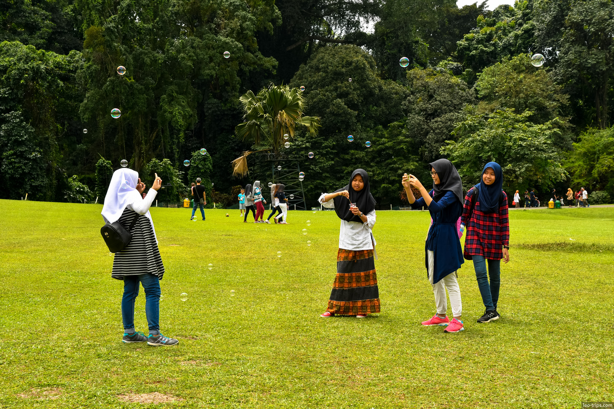 girls blowing soap bubbles lawn bogor bogor