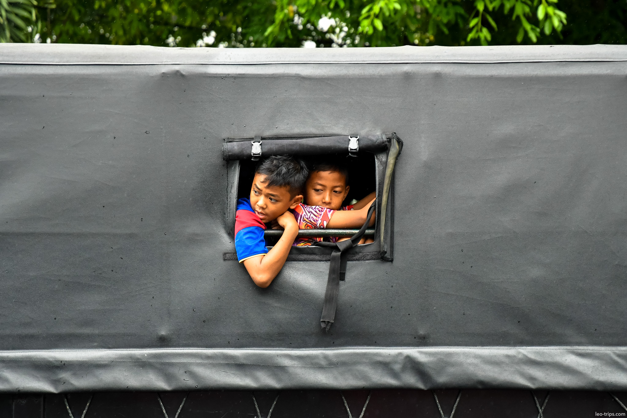 two boys peeking from military truck window bogor bogor