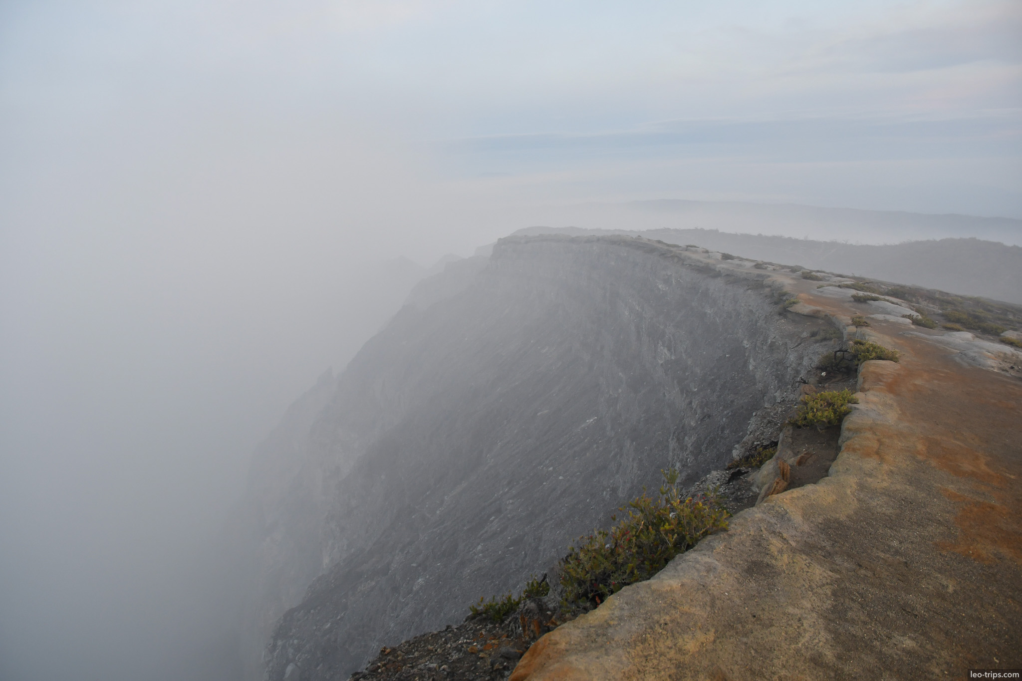 crater rim edge disappearing into fog ijen ijen lake