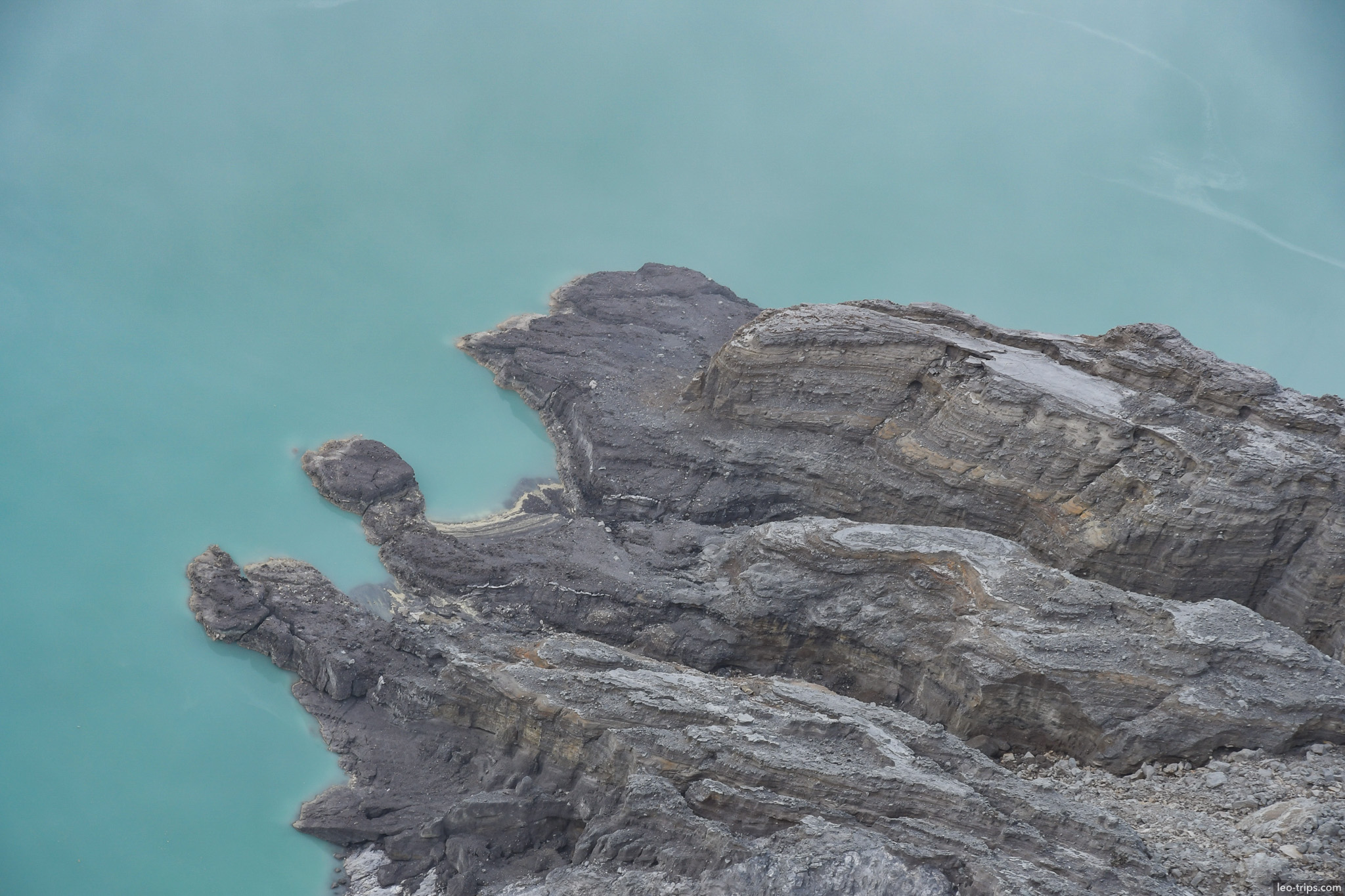 layered rock formations above acid lake ijen ijen lake