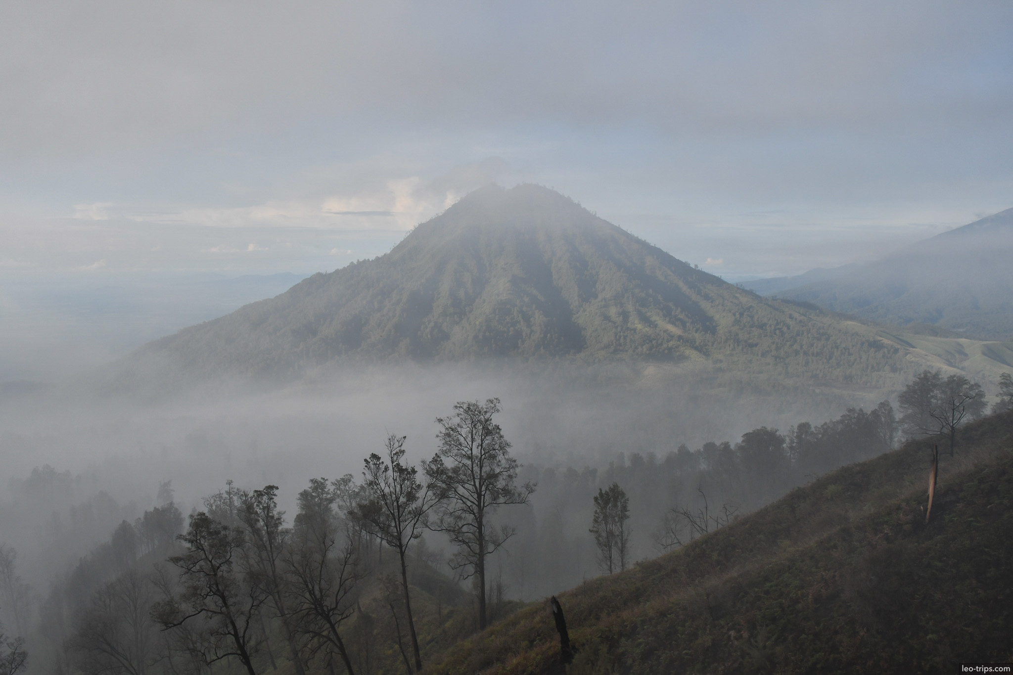 mount raung conical peak through morning mist ijen ijen lake