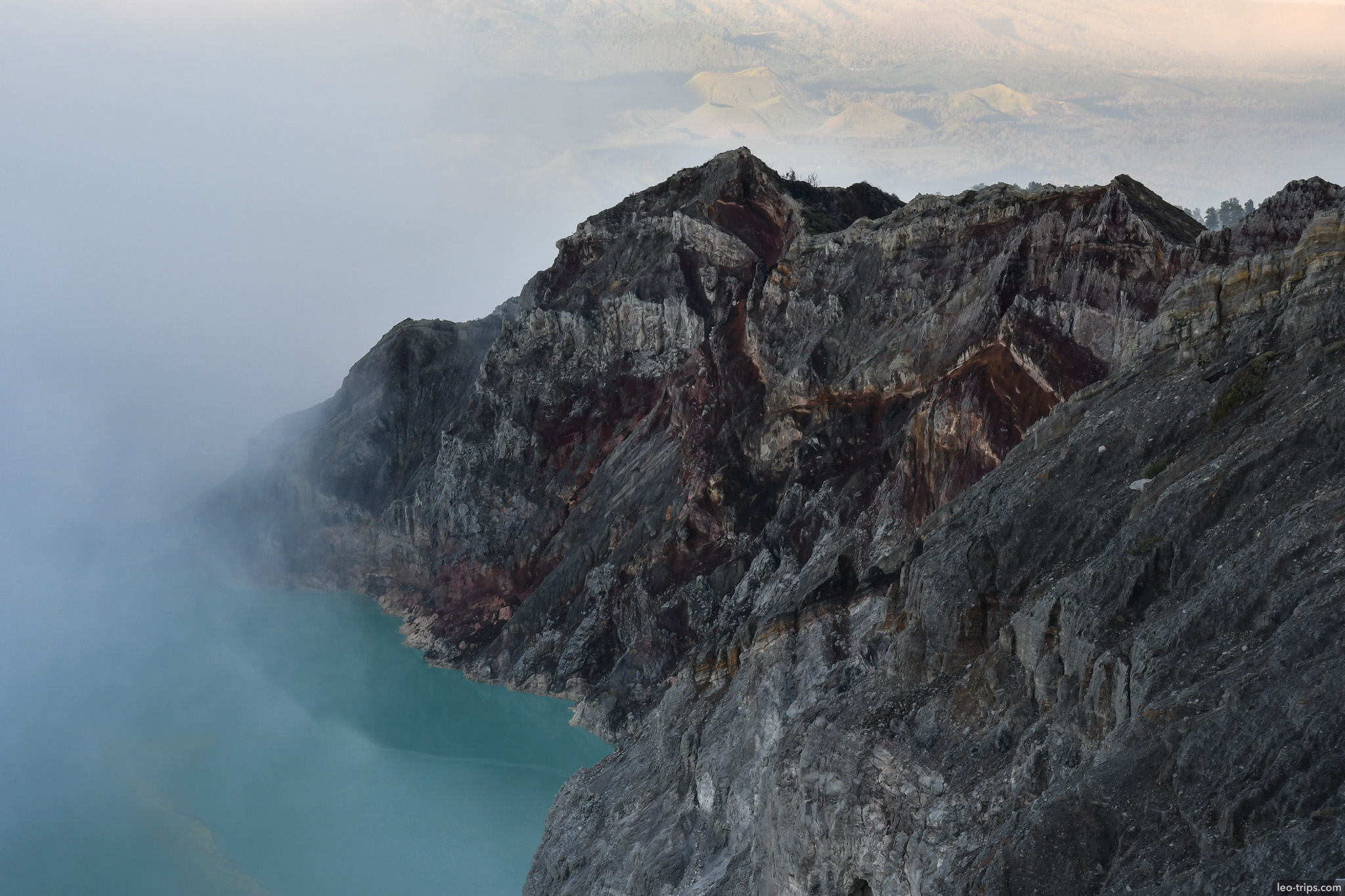 rugged crater cliffs above turquoise lake ijen ijen lake