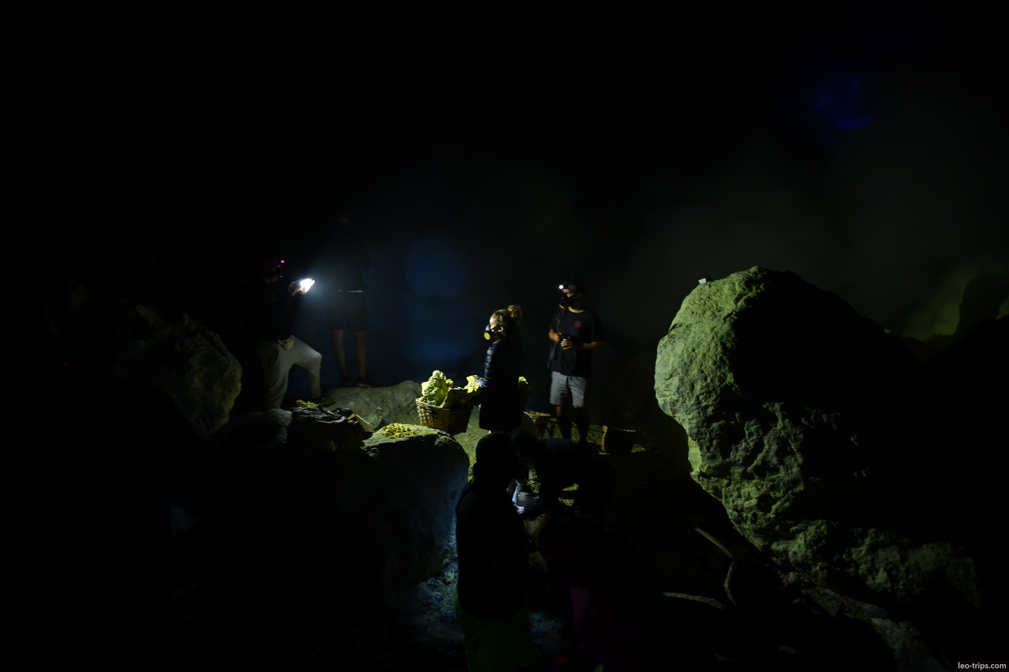 sulfur miners with headlamps inside ijen crater ijen lake