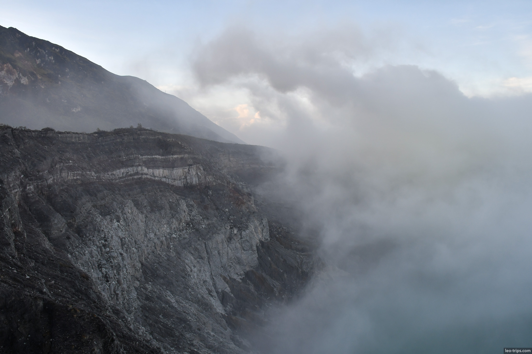 volcanic crater wall with sulfuric steam ijen ijen lake