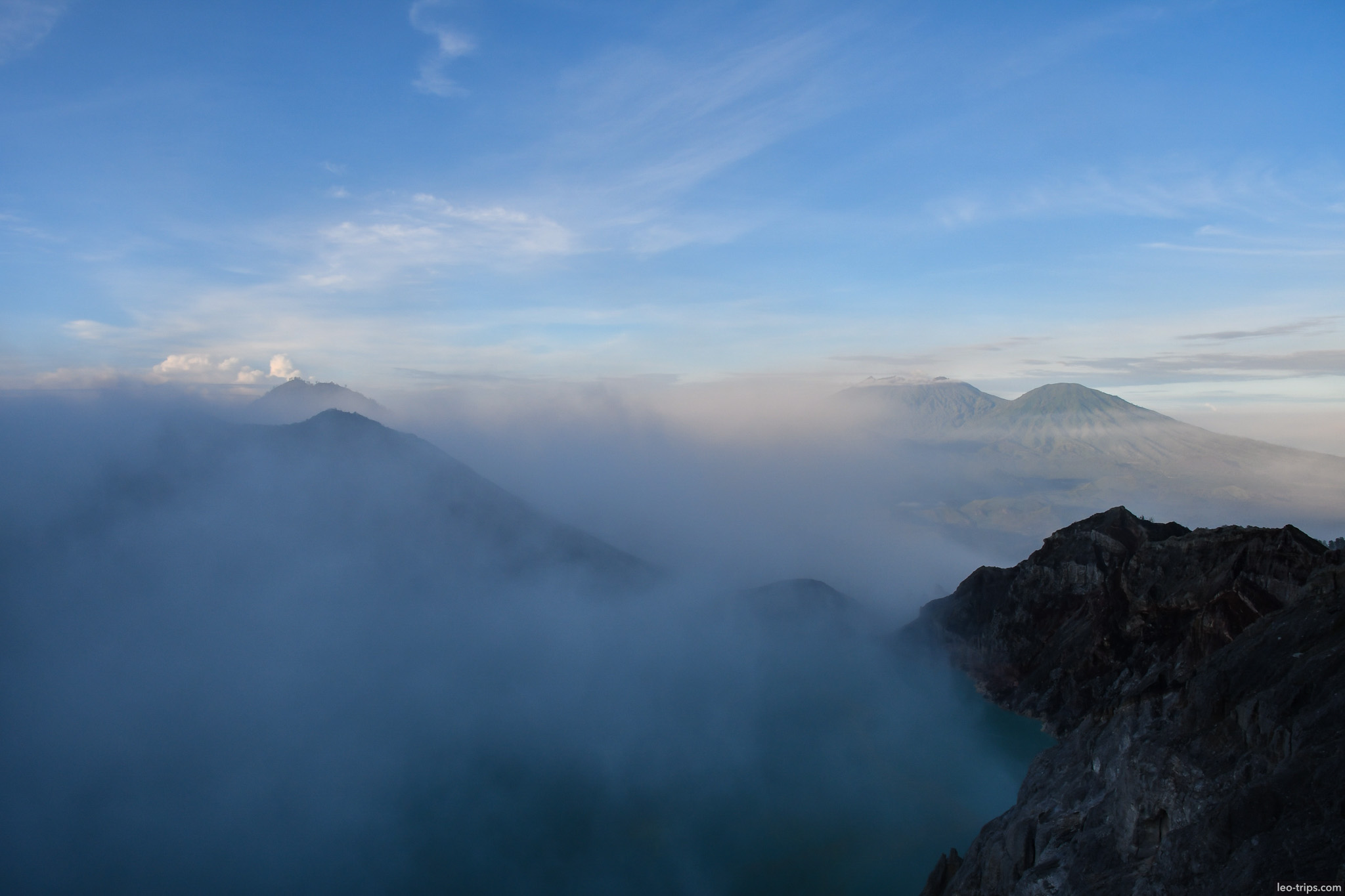 volcanic peaks above clouds from crater rim ijen ijen lake