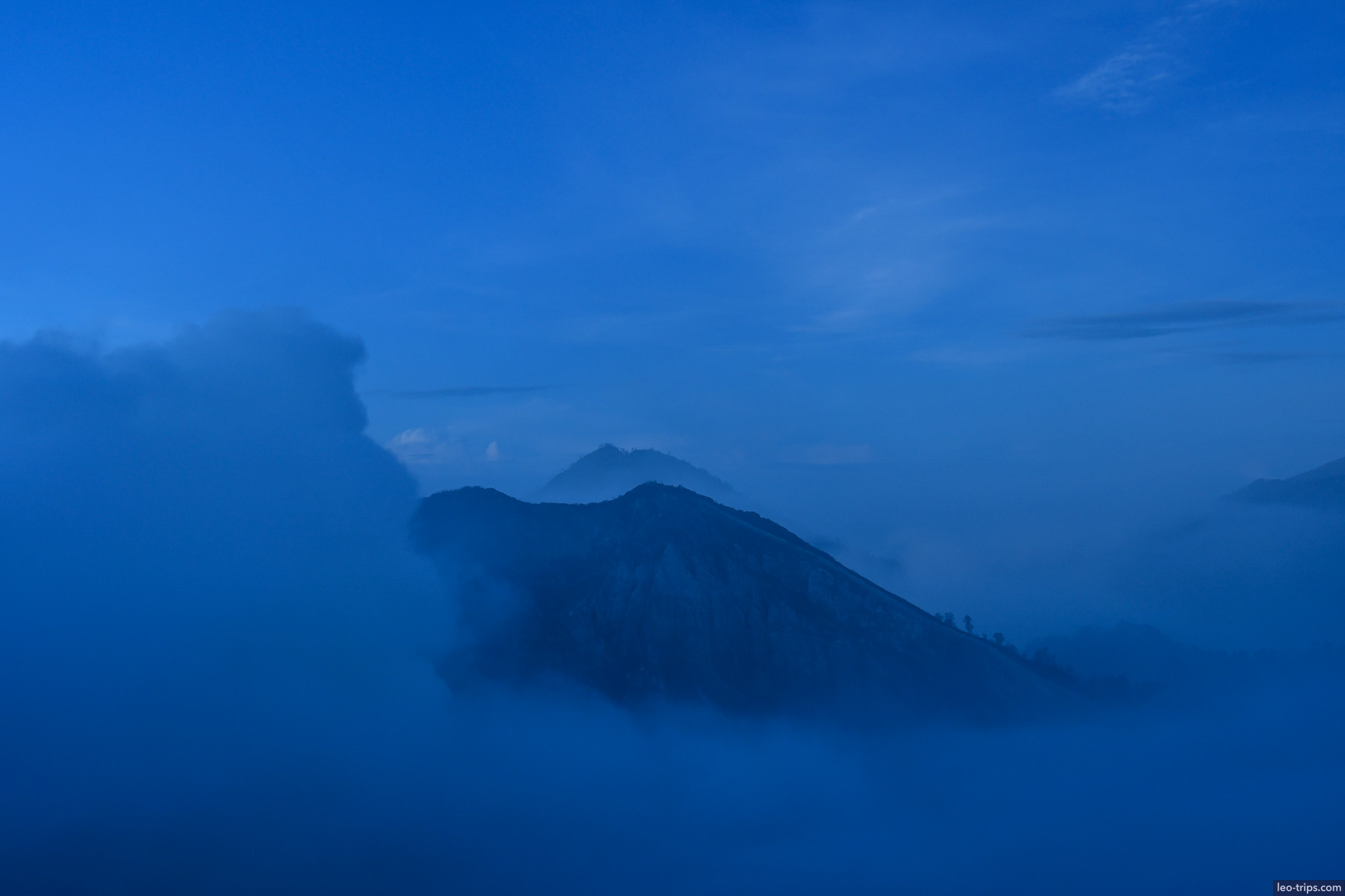 volcanic peaks in blue predawn mist ijen ijen lake