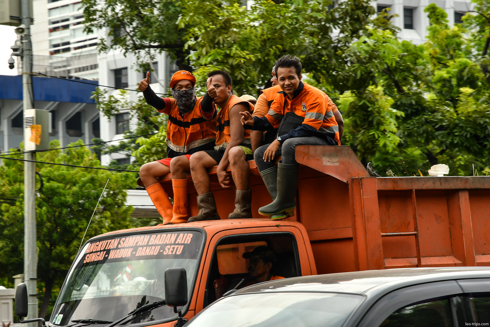 sanitation workers riding orange truck jakarta jakarta