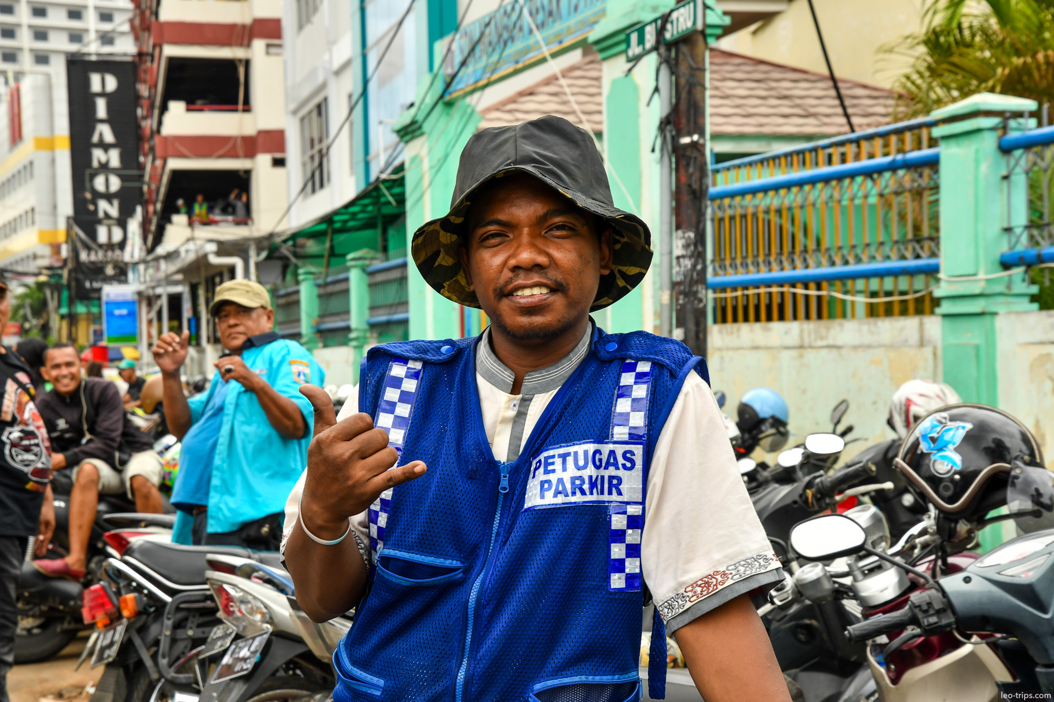 smiling parking attendant blue vest jakarta jakarta
