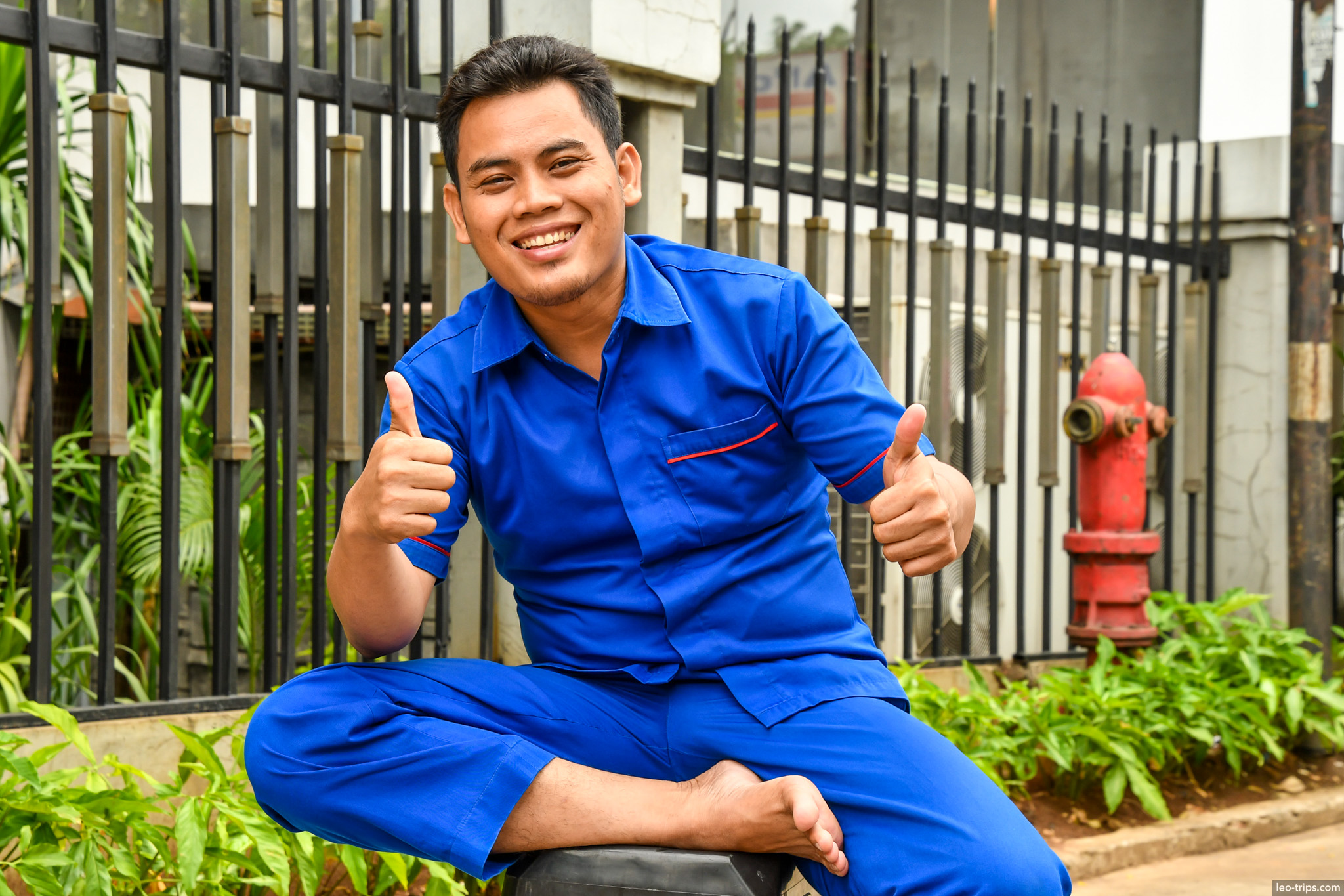 young man thumbs up blue uniform jakarta jakarta