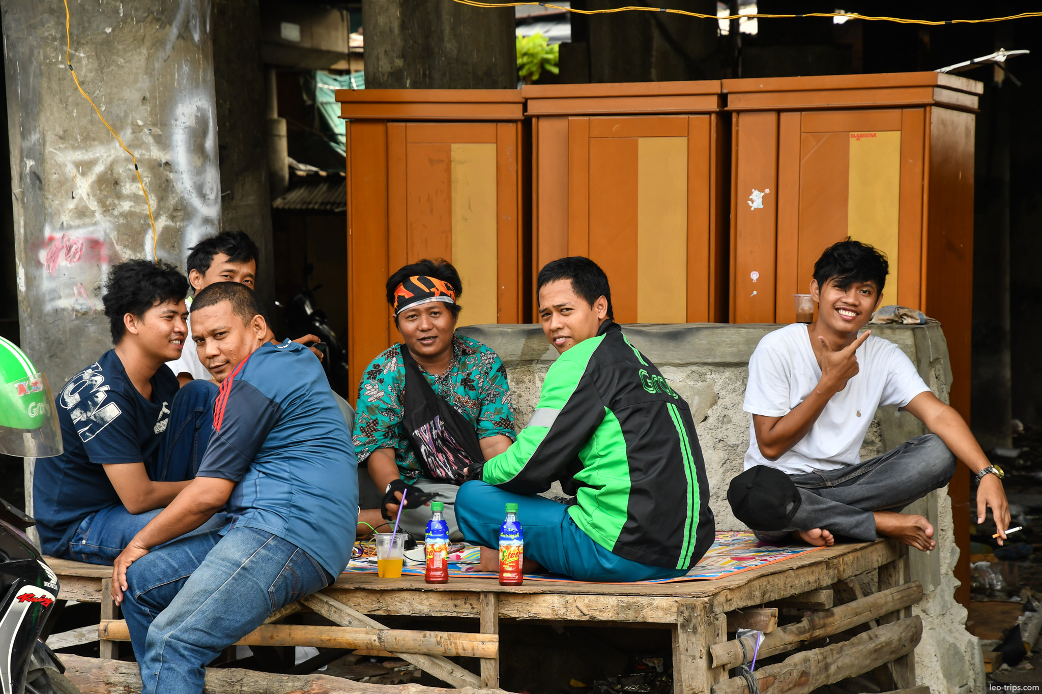 young men hanging out on wooden cart jakarta jakarta