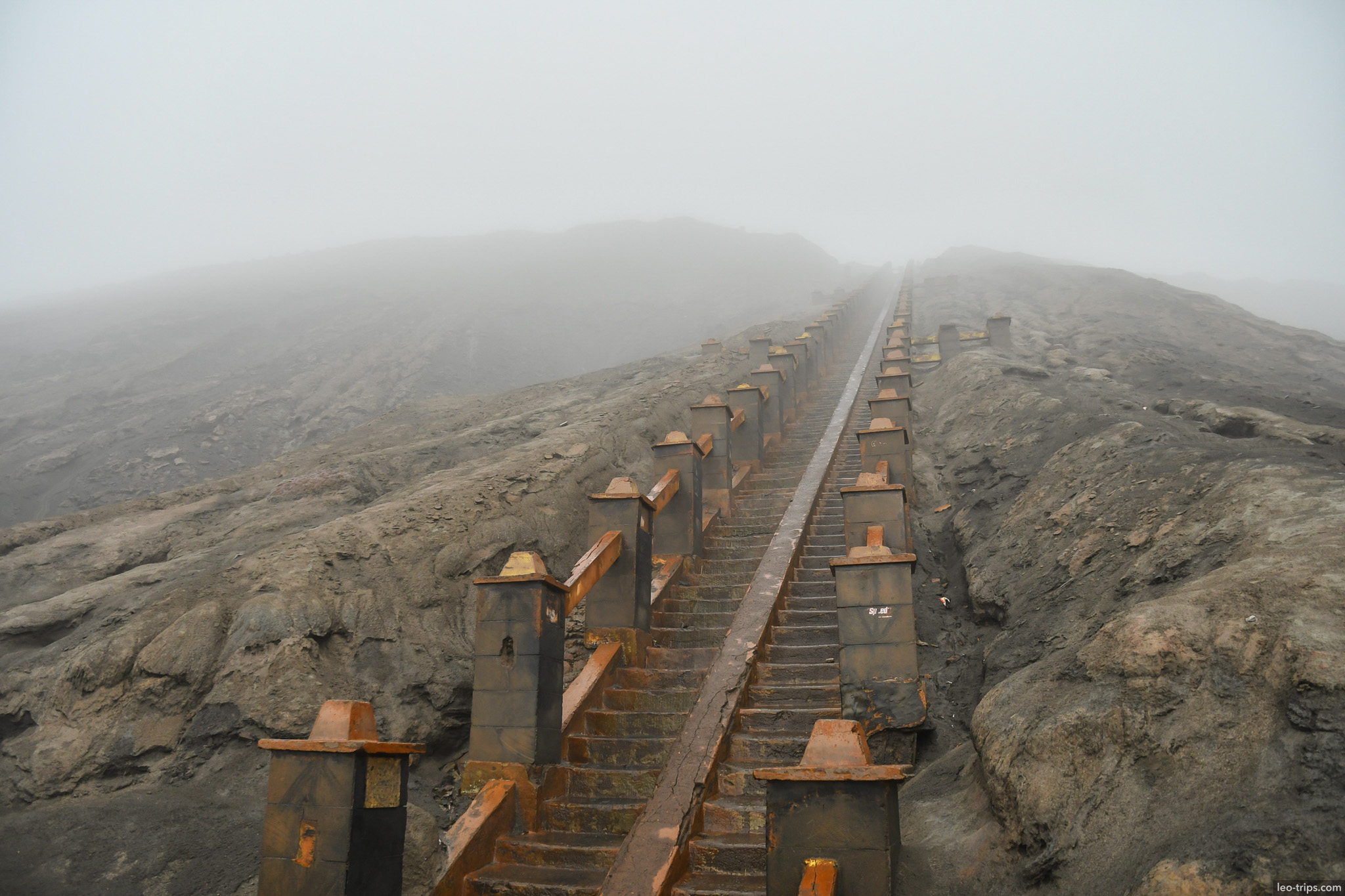 concrete stairway ascending bromo slope in fog mount bromo