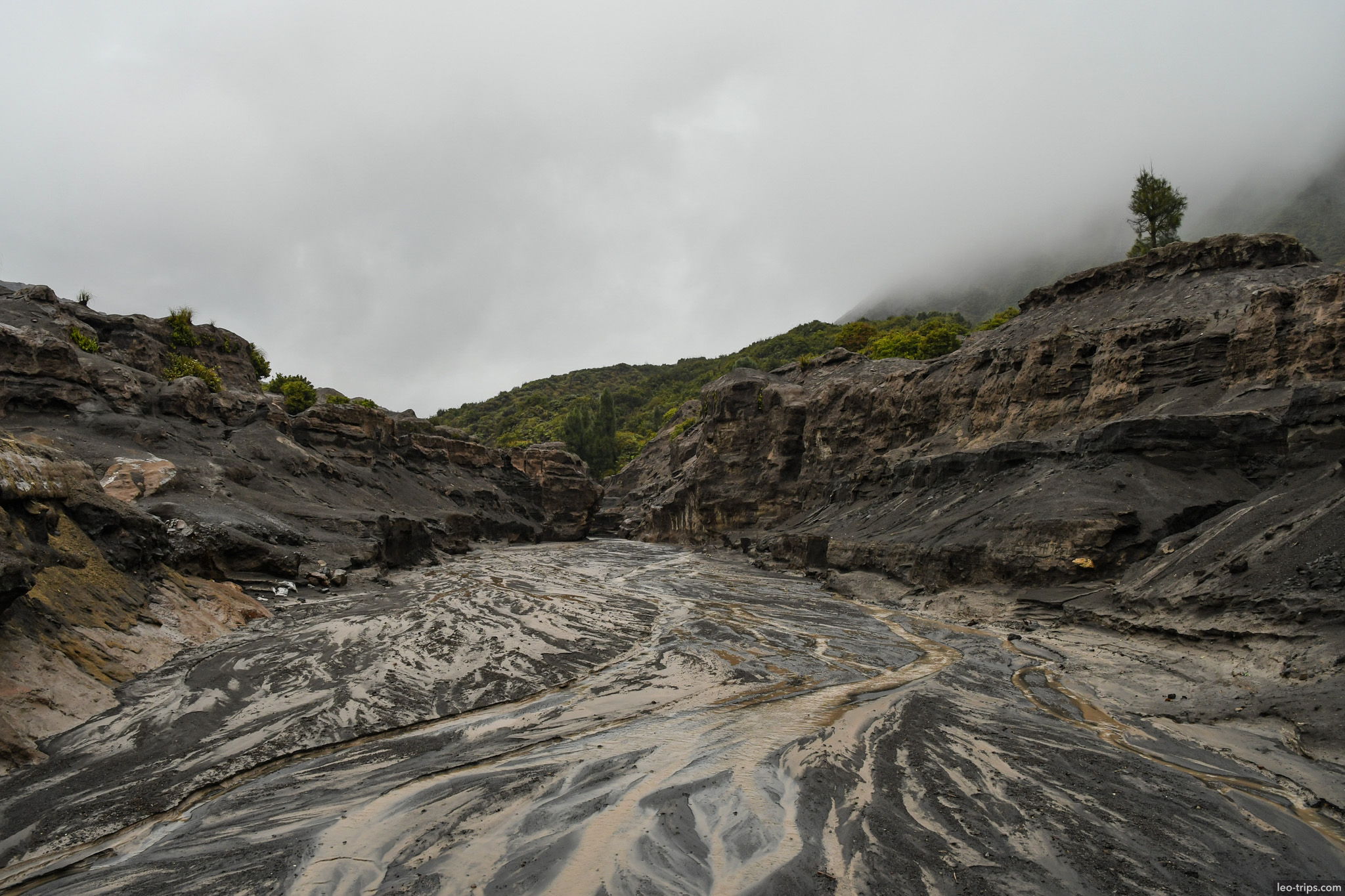dried mud riverbed through volcanic gorge mount bromo