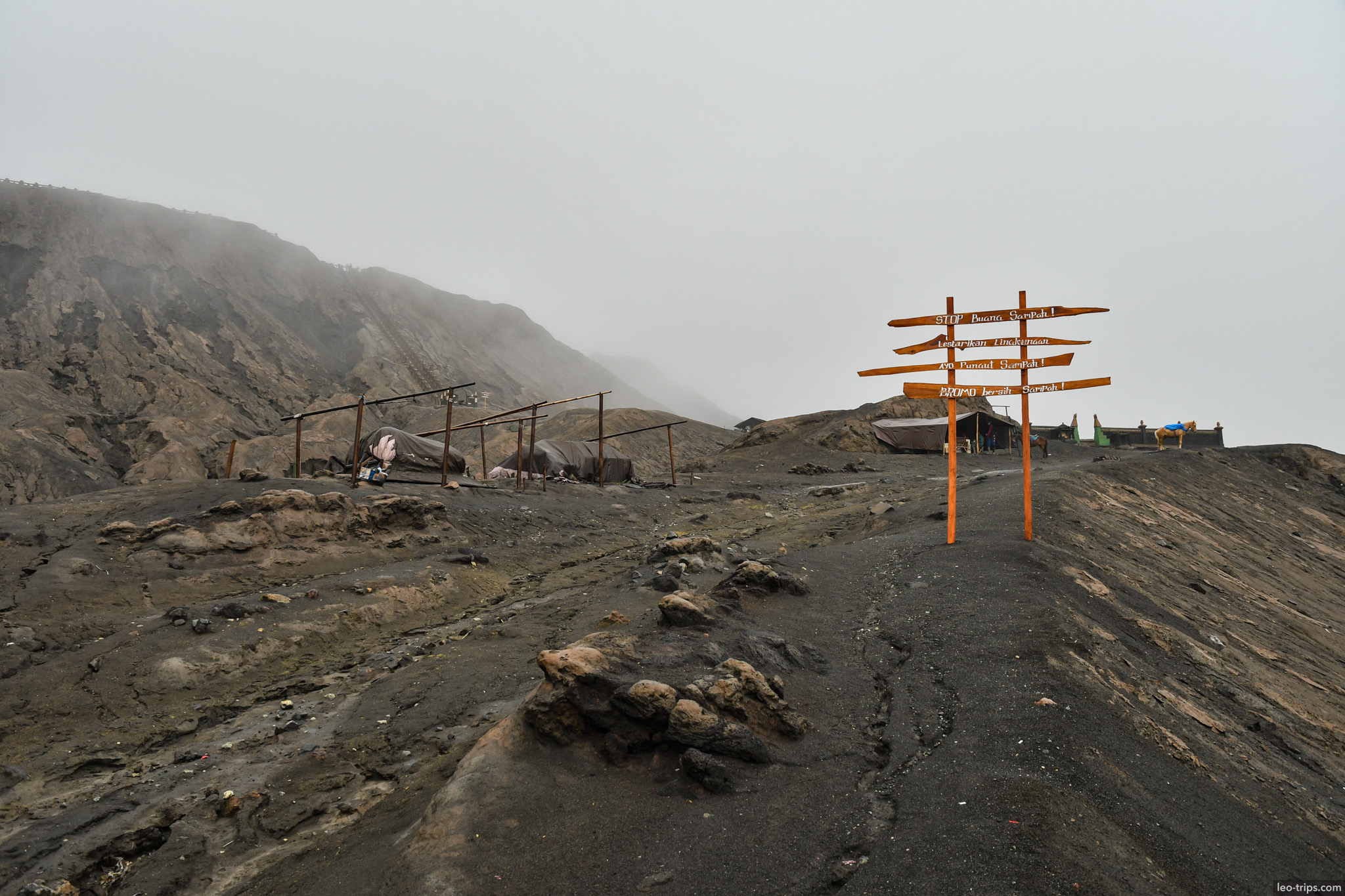 wooden signpost and shelters near bromo crater mount bromo